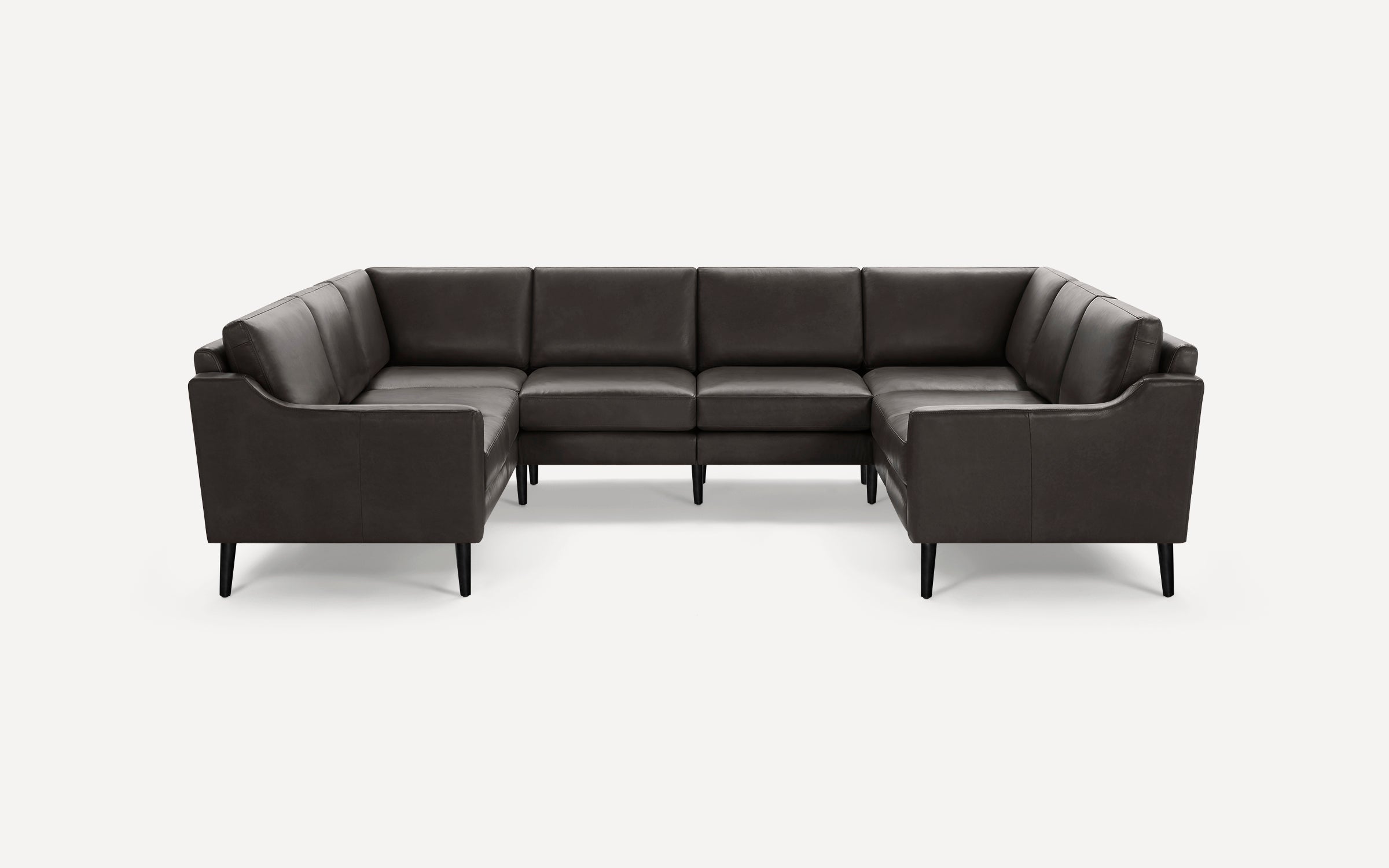 Dark gray leather sectional sofa with clean lines and slim black legs, arranged in a U-shape against a plain white background.