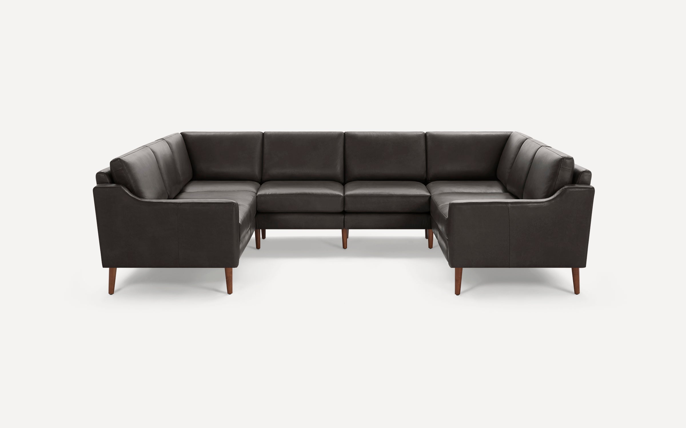 Dark gray leather U-shaped sectional sofa with wooden tapered legs and cushioned back and seats.