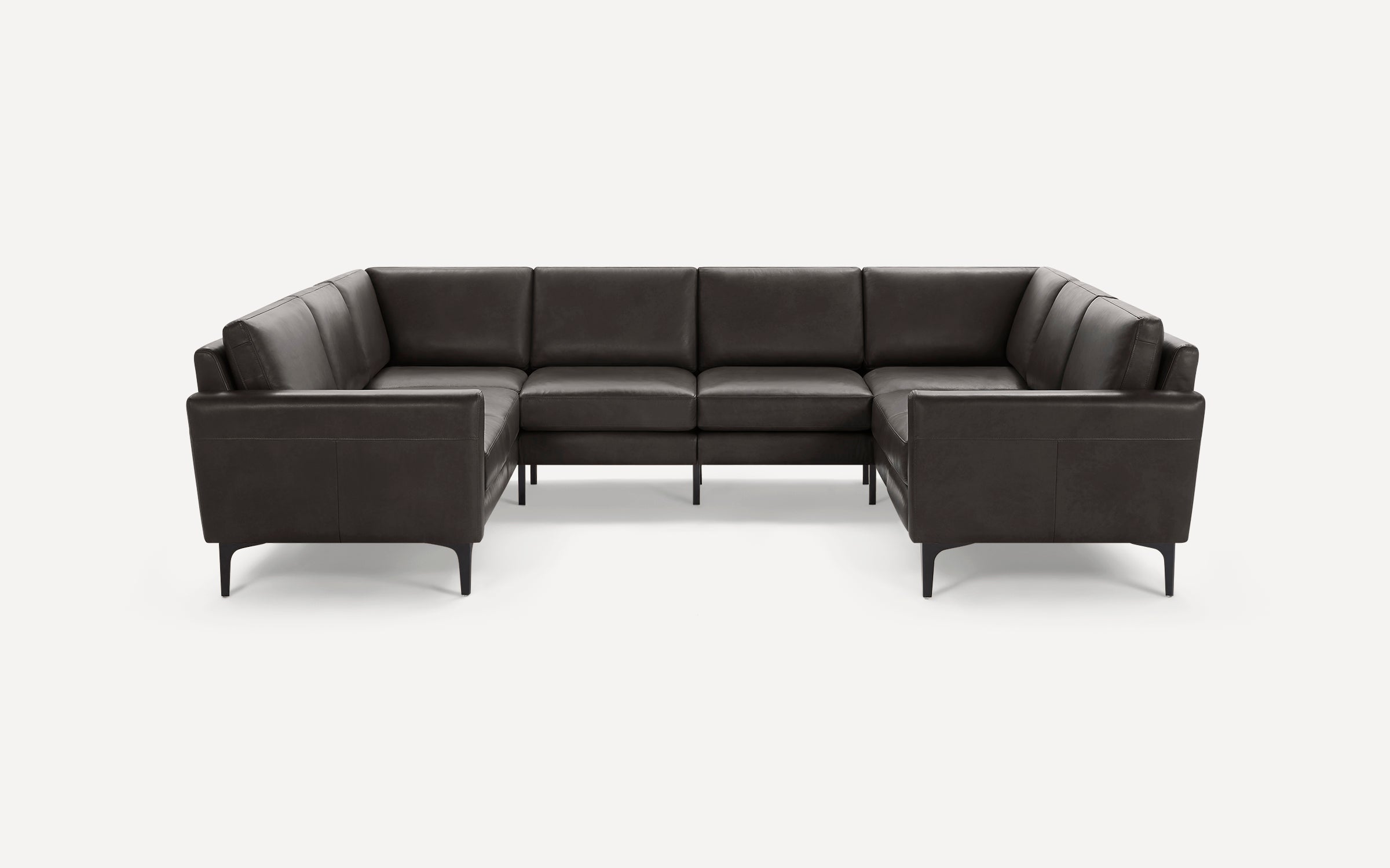 Dark gray leather U-shaped sectional sofa with clean lines, slim armrests, and short black legs on white background.