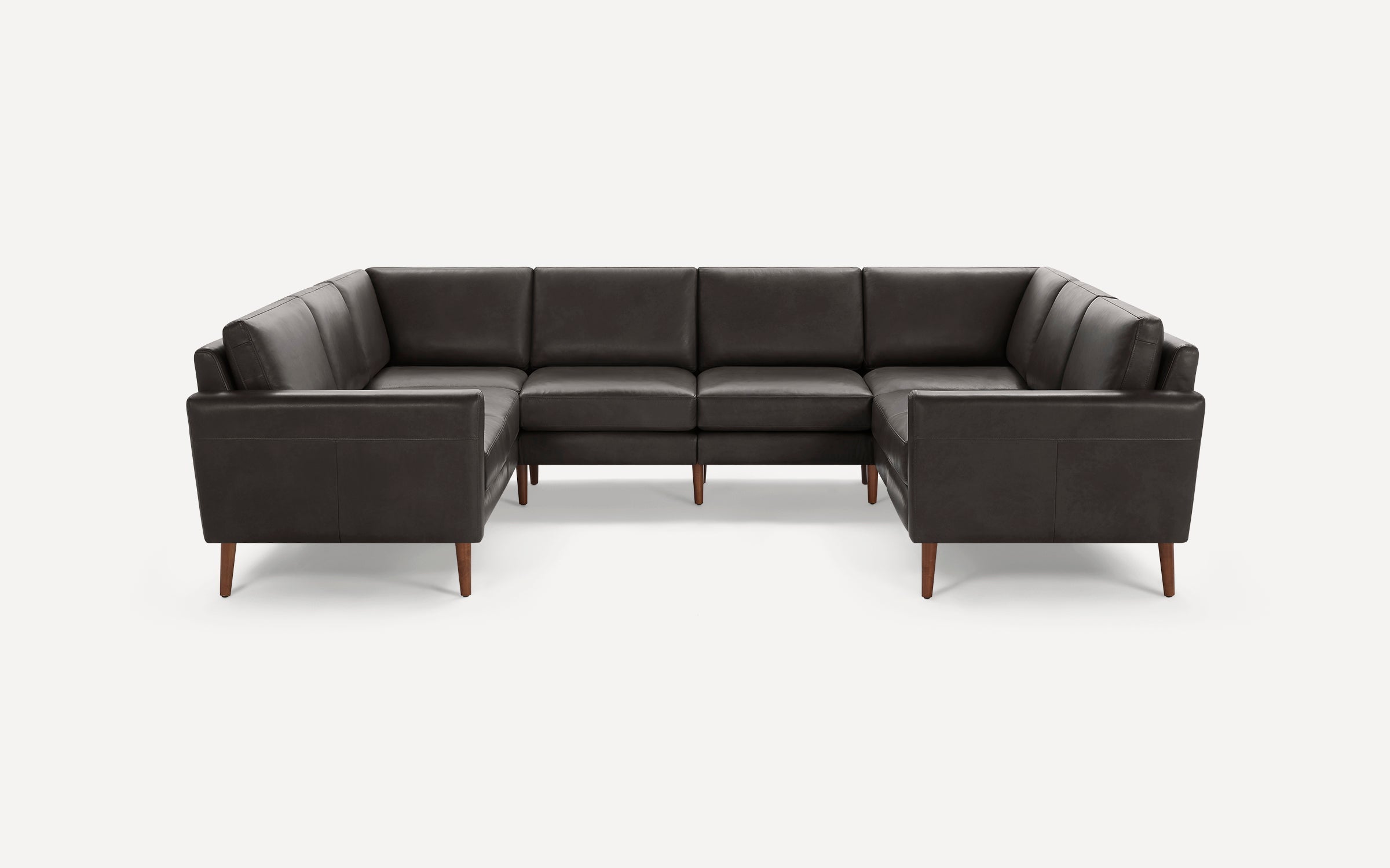 Large modern U-shaped sectional sofa with dark gray upholstery and wooden legs on a white background.