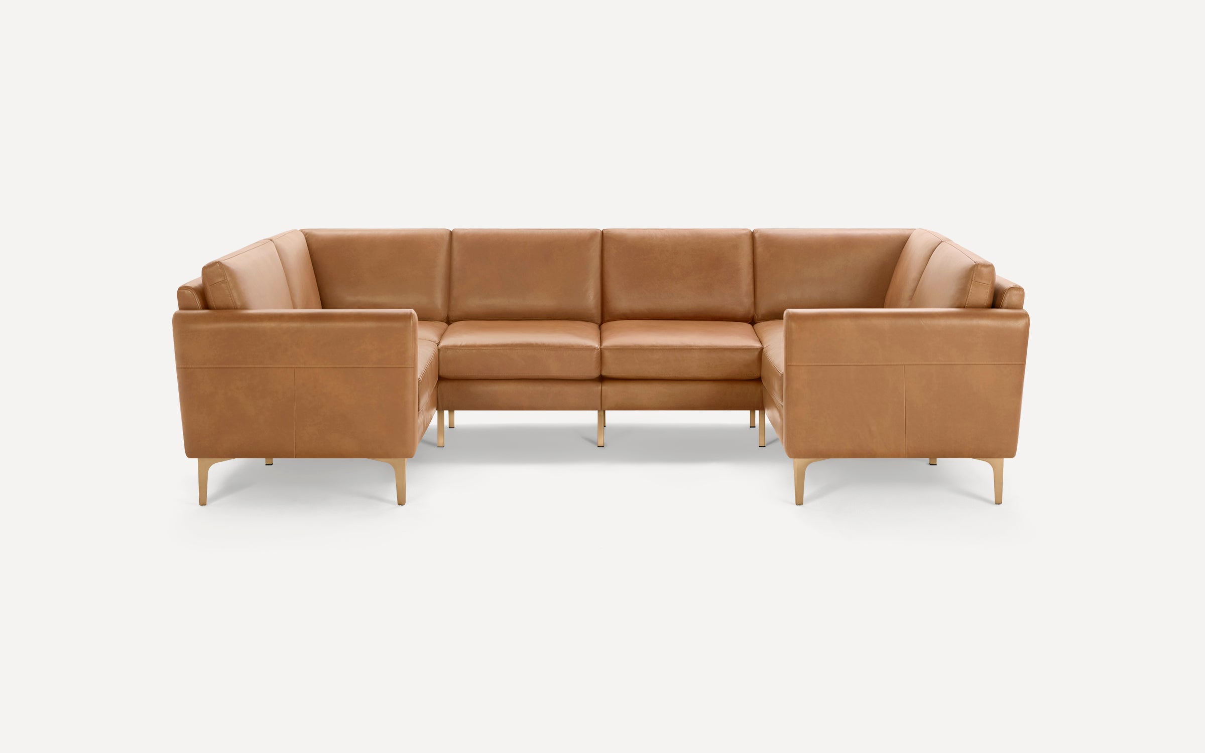 Modern U-shaped sectional sofa upholstered in light brown leather with slim wooden legs, clean lines, and cushioned seating.