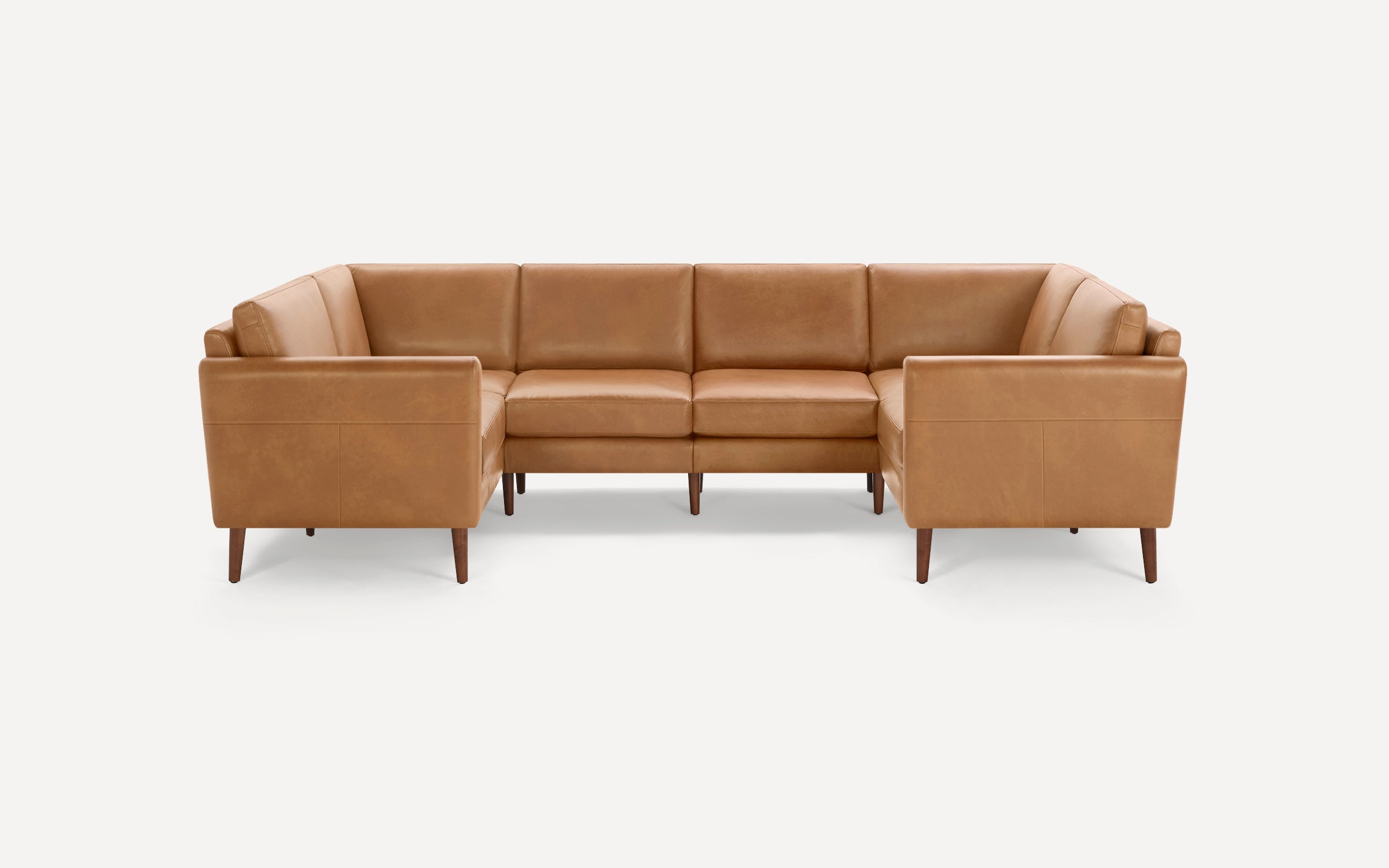 Brown leather U-shaped sectional sofa with clean lines, wooden tapered legs, and box cushions on neutral background.