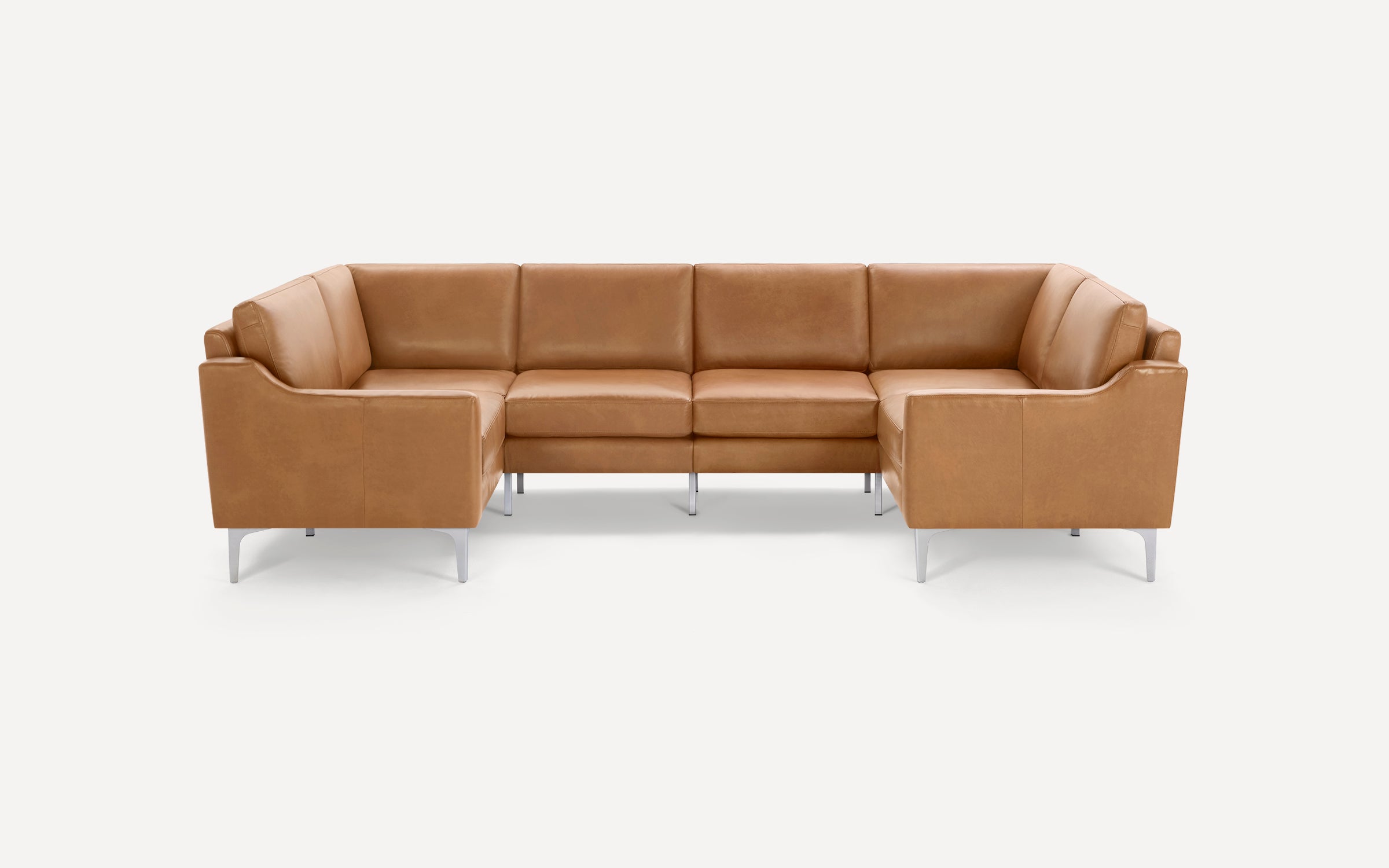 Modern U-shaped sectional sofa in tan leather with cushioned seats and backrests, supported by sleek metal legs.