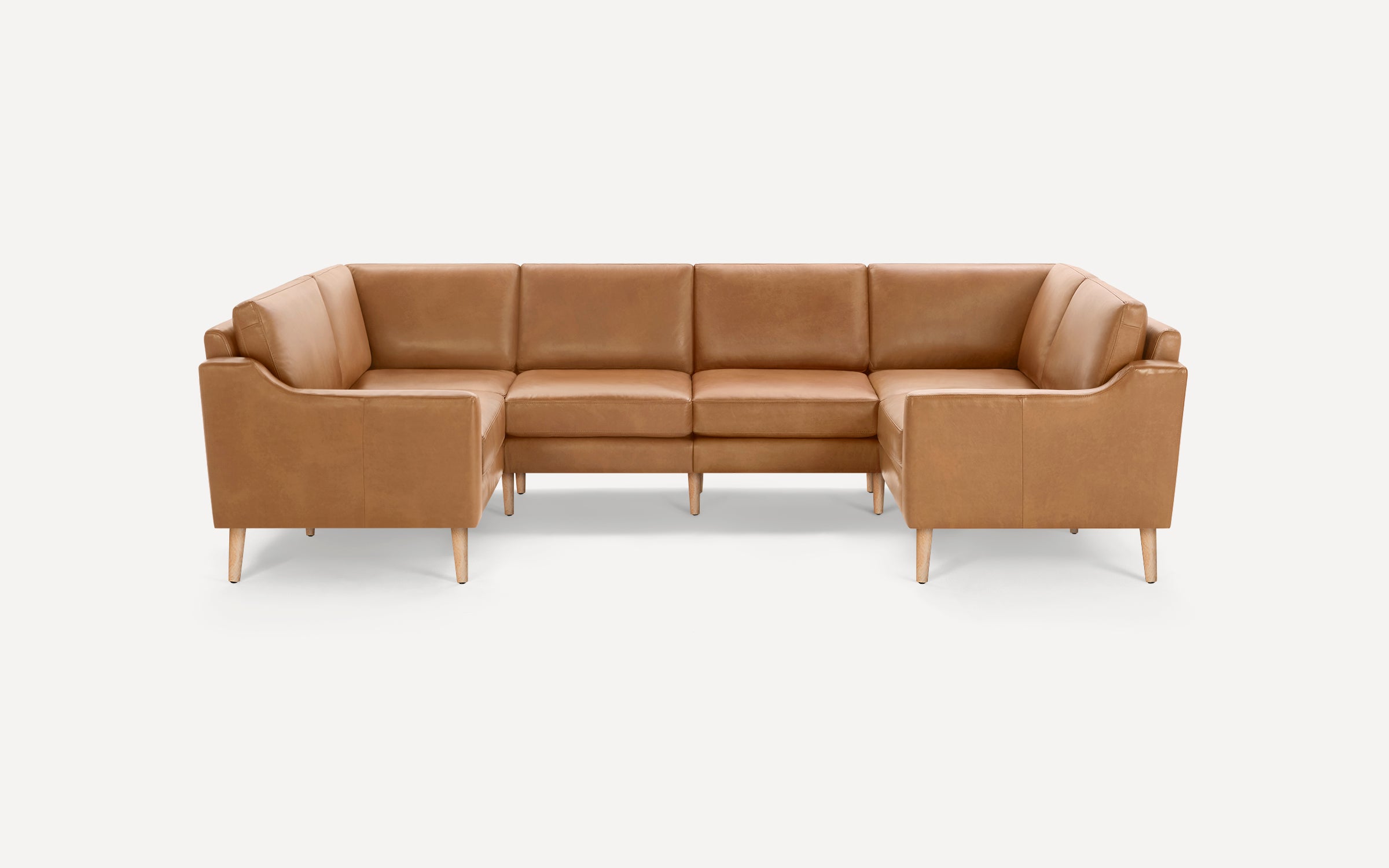 Modern sectional sofa with caramel leather upholstery, straight wooden legs, and a U-shaped design for spacious seating.