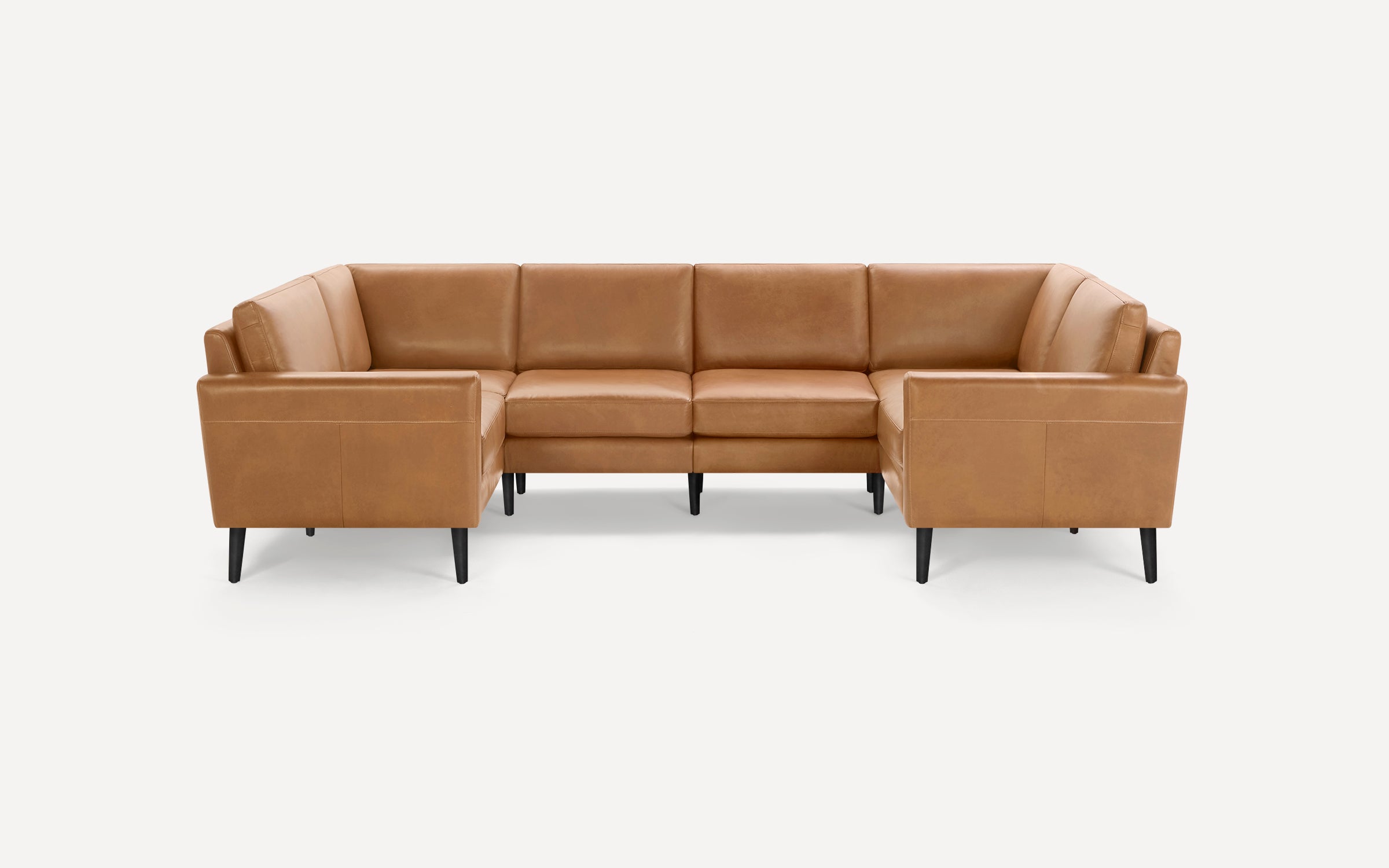 U-shaped tan leather sectional sofa with clean lines, cushioned seats, backrests, and black tapered wooden legs.