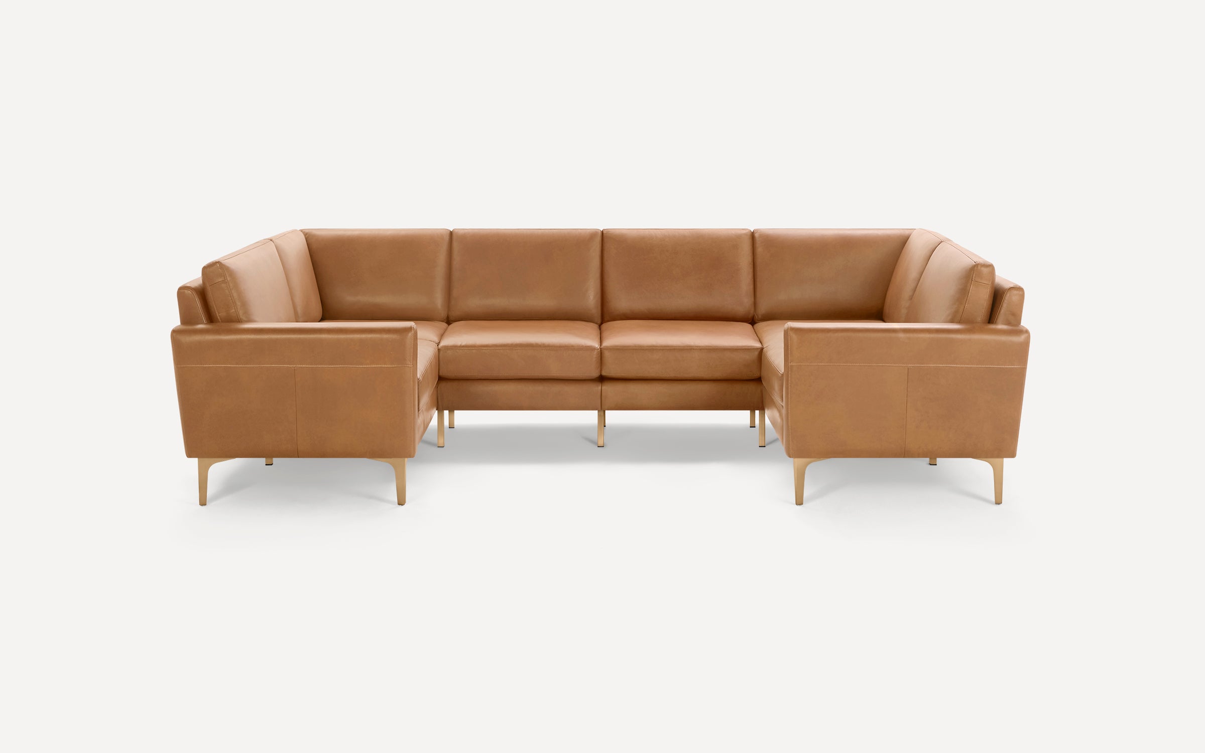 U-shaped modern sectional sofa in tan leather with clean lines and slim wooden legs, pictured on white background.