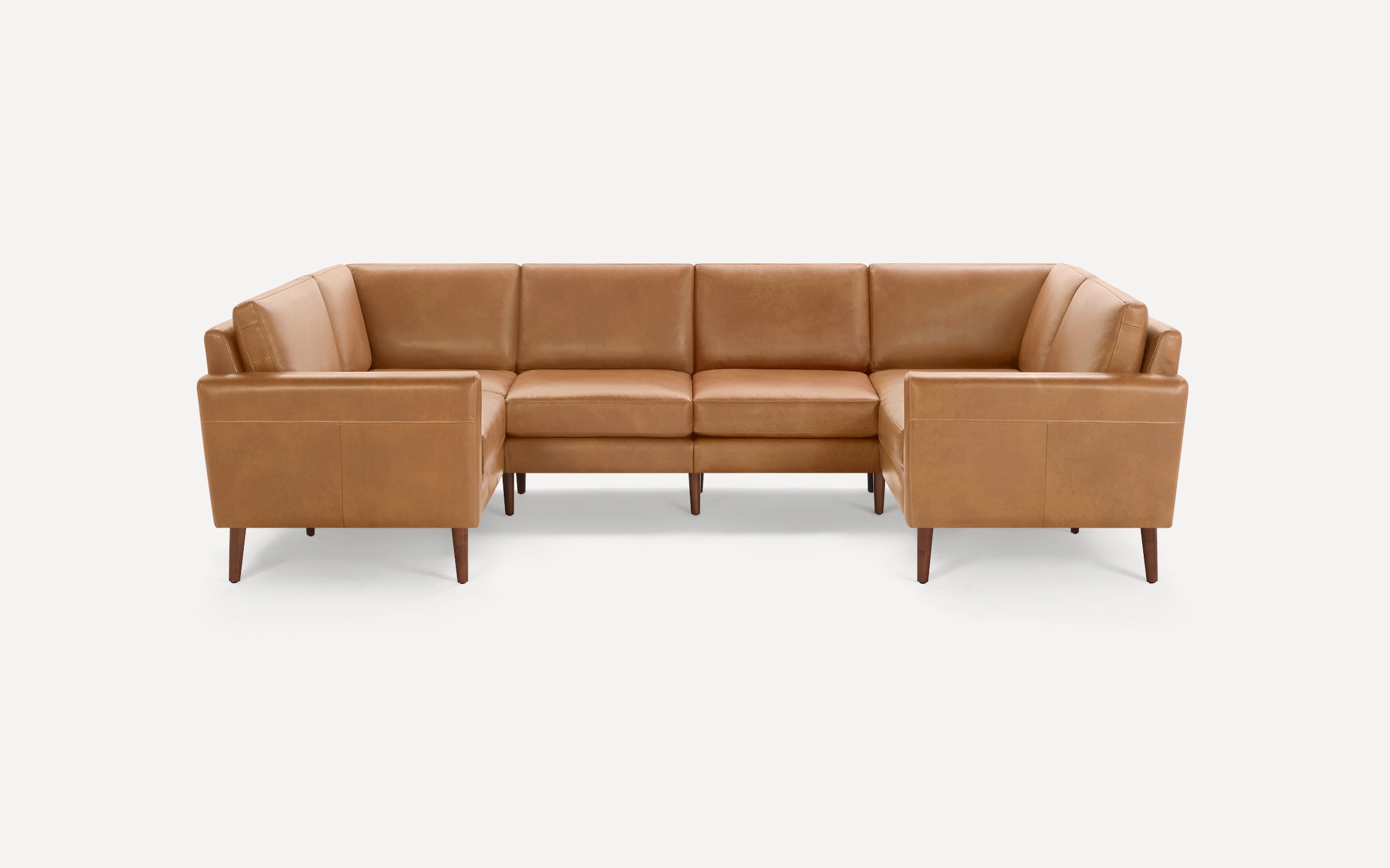 Camel brown leather sectional sofa with clean lines, wooden tapered legs, and cushioned seats and backrests.