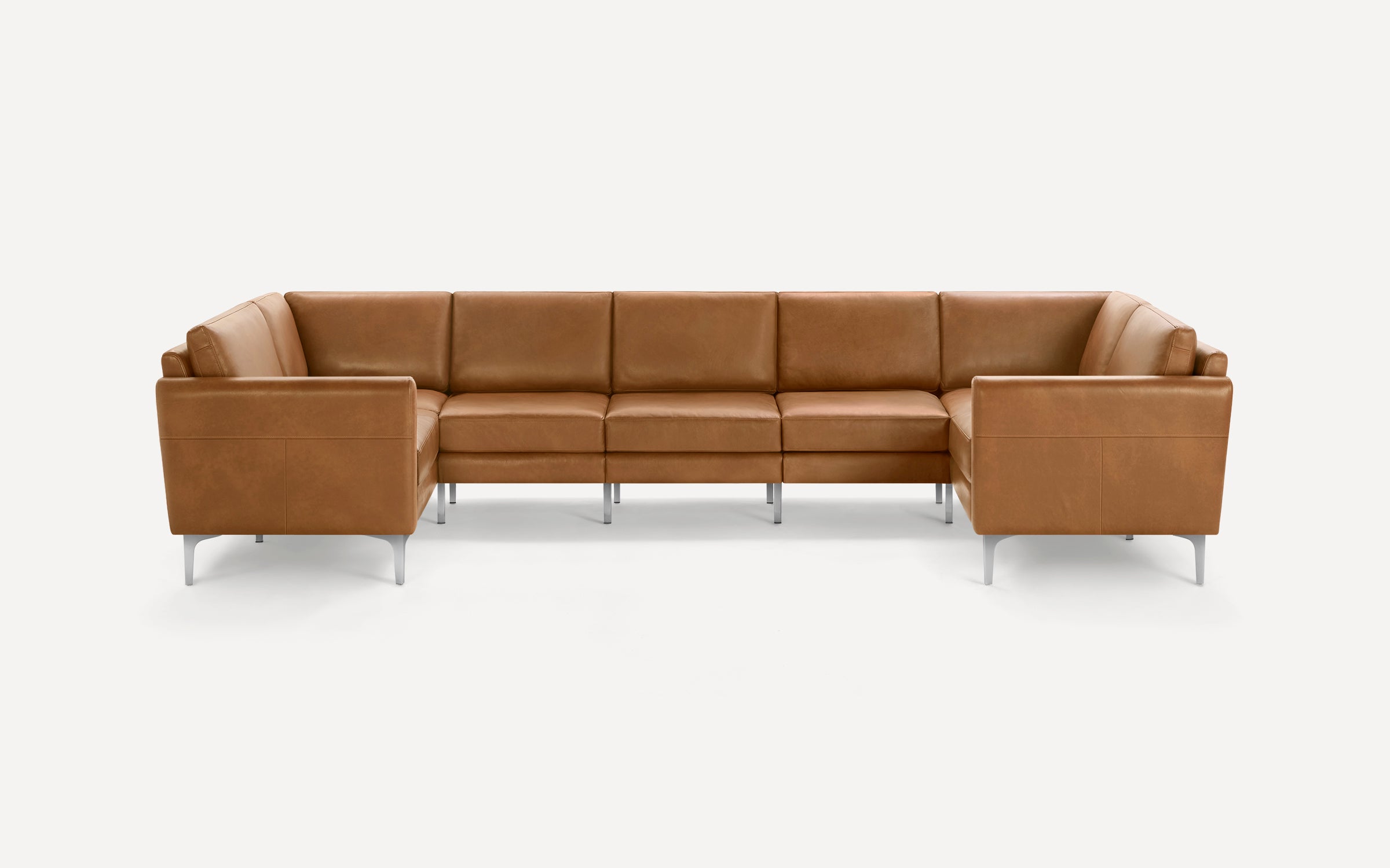 Modern U-shaped sectional sofa in tan leather with clean lines and slim silver metal legs on a white background.
