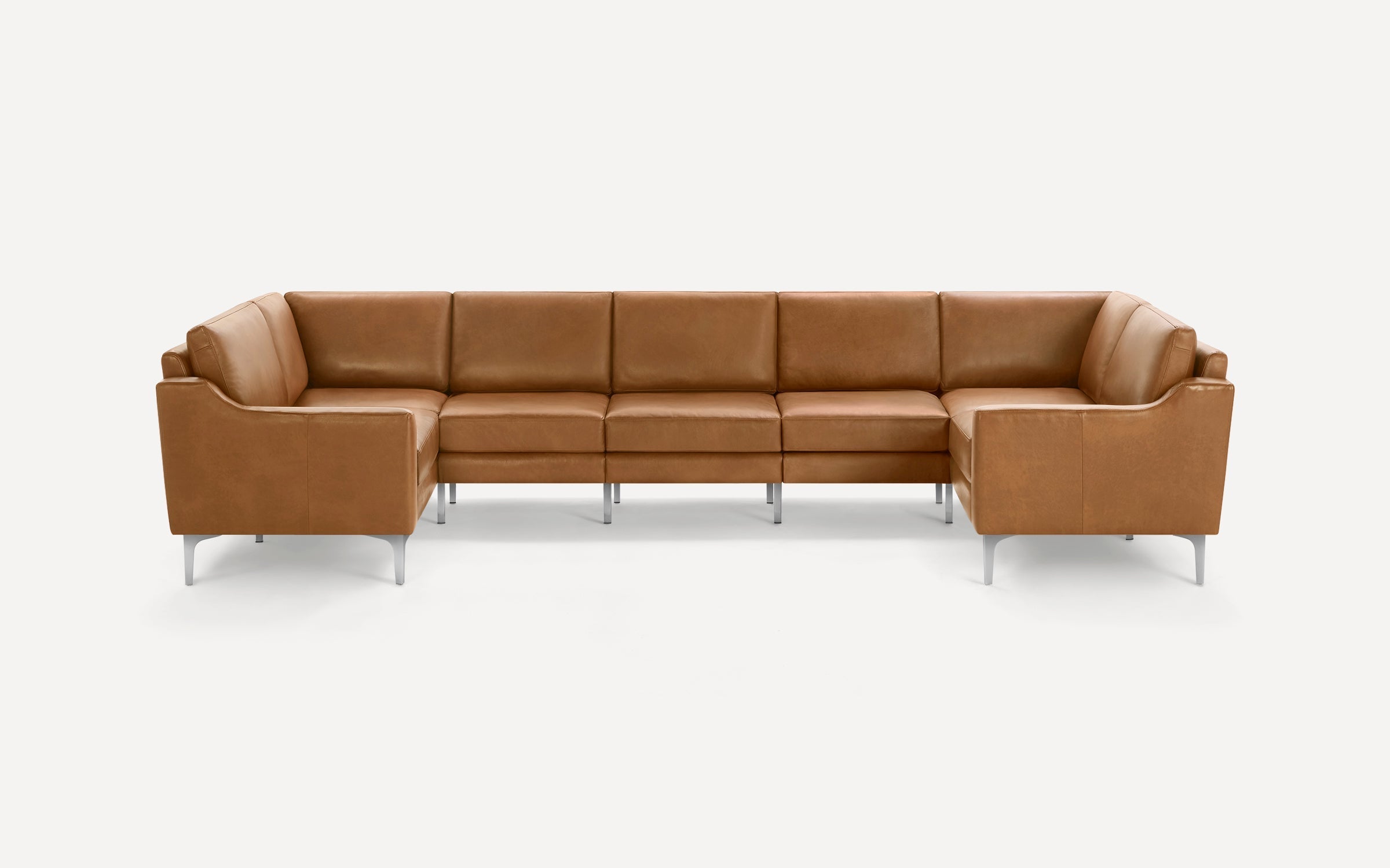 Large modern sectional sofa in light brown leather with clean lines and silver metal legs, set against a white background.