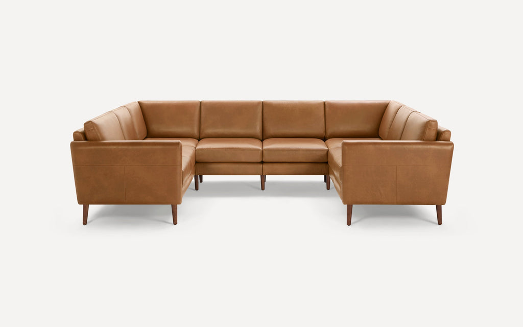Modern U-shaped sectional sofa in caramel brown leather with clean lines and wooden legs on a white background.