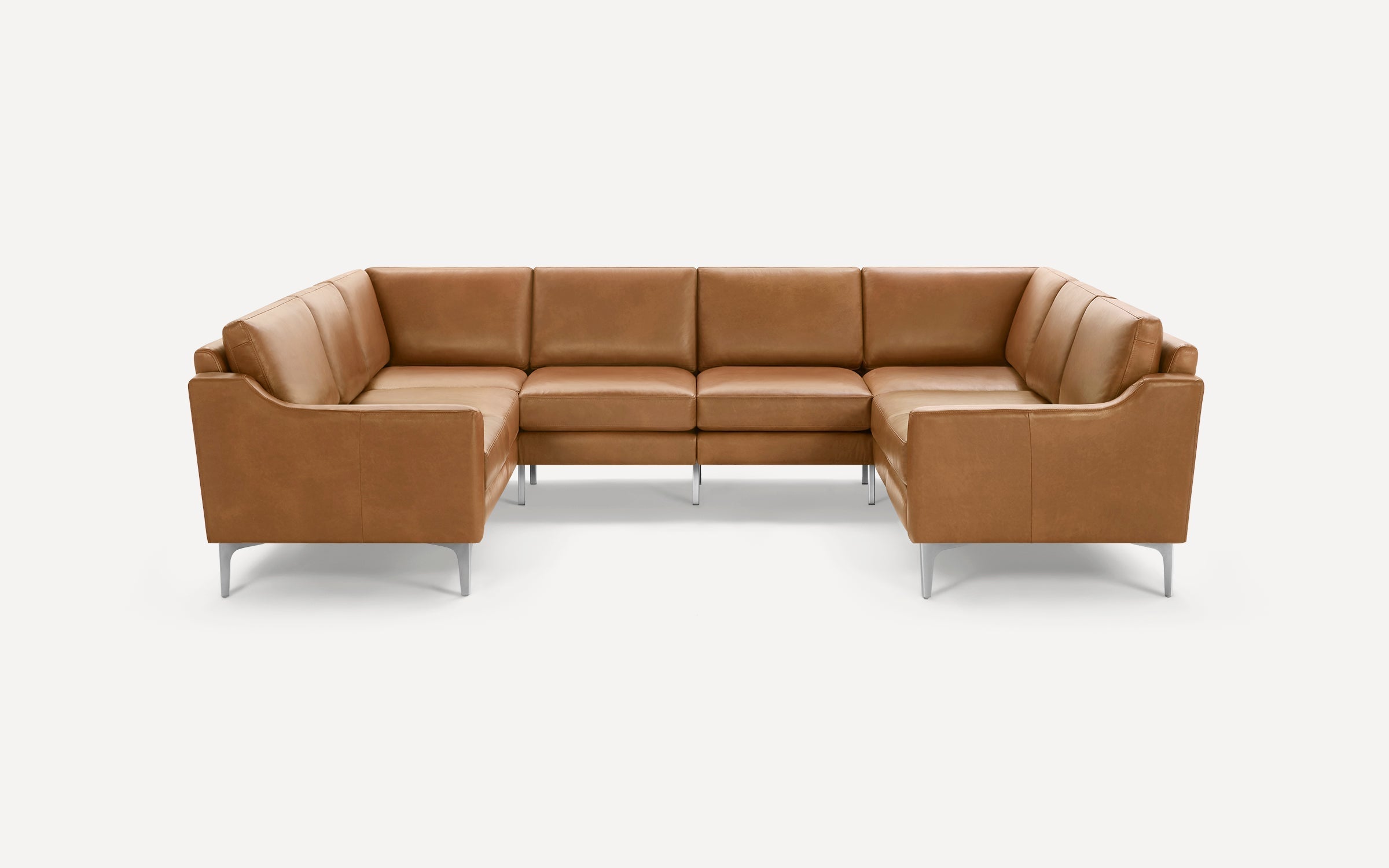 Modern L-shaped sectional sofa with tan leather upholstery and slim metal legs, designed for spacious seating.
