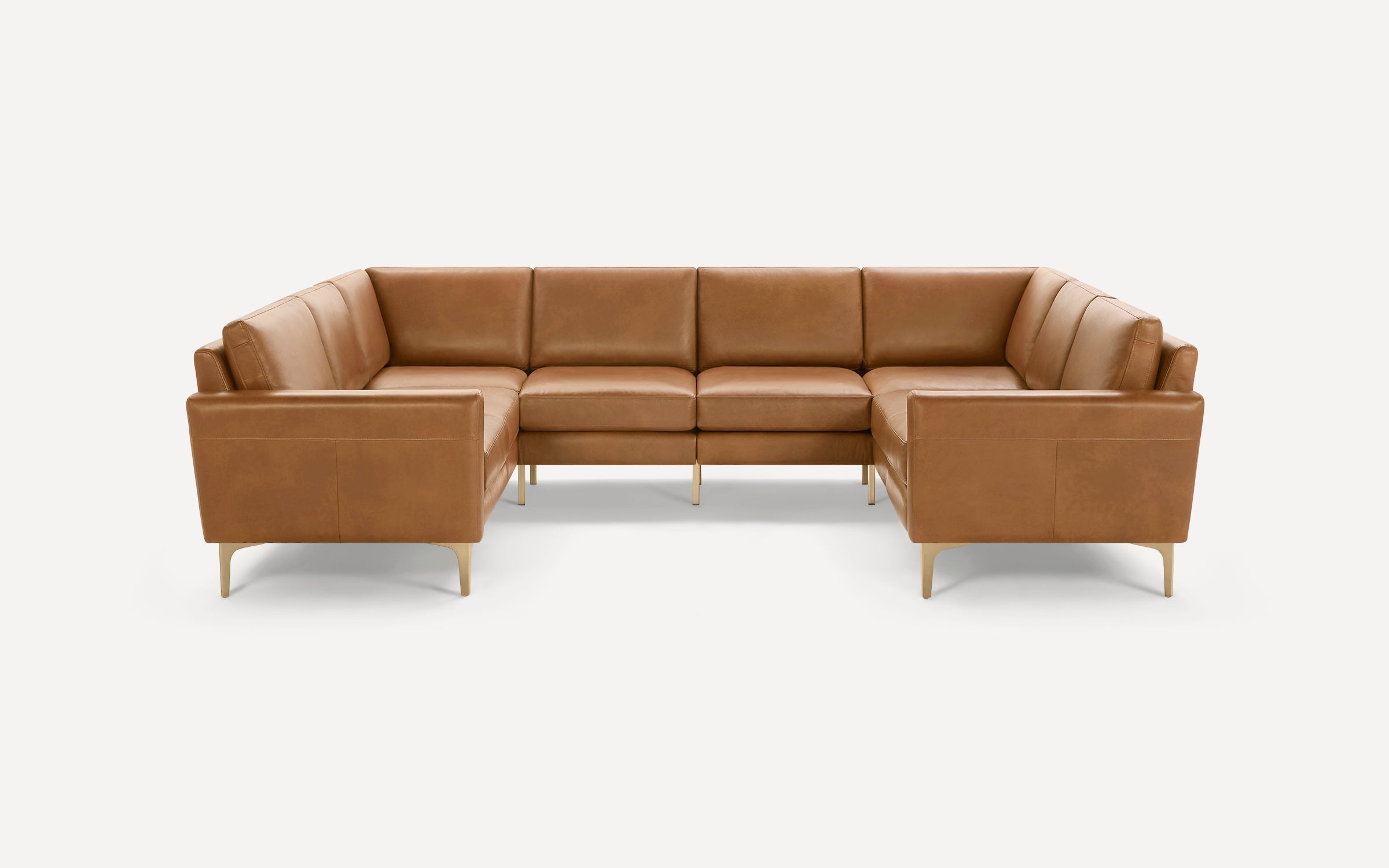 U-shaped sectional sofa with light brown leather upholstery, clean lines, and slim wooden legs on a white background.