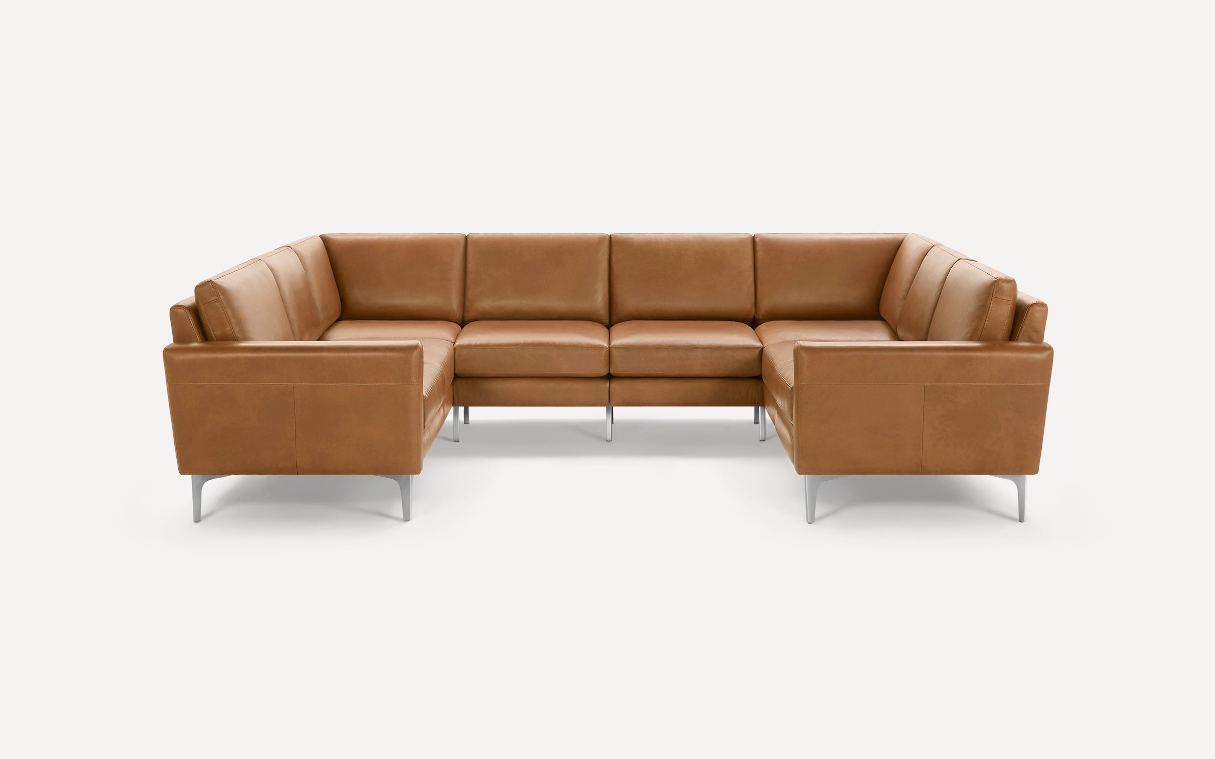Modern L-shaped sectional sofa in caramel brown leather with minimalist metal legs, sleek cushions, and clean lines on white background.