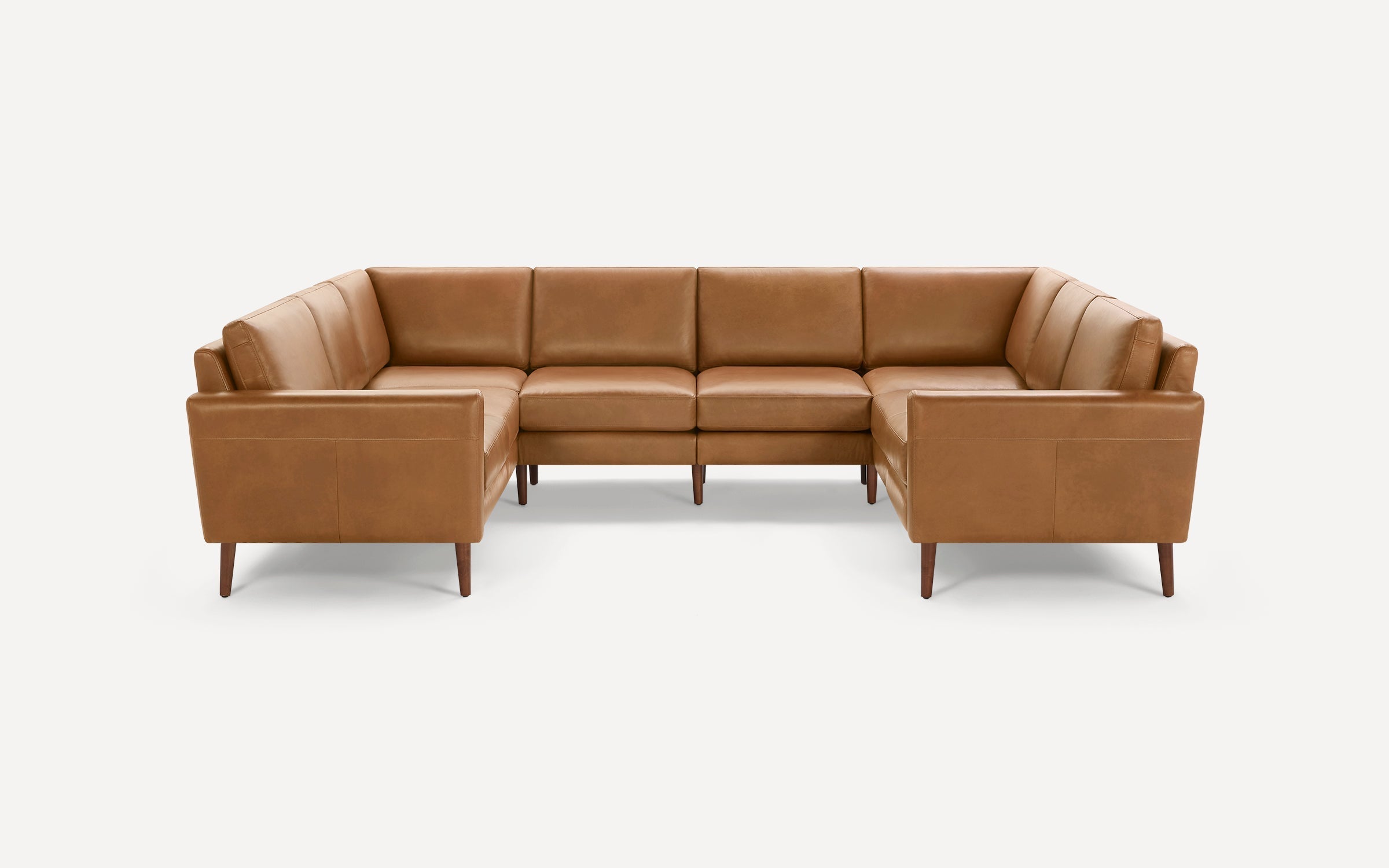 L-shaped sectional sofa with tan leather upholstery, clean lines, and wooden tapered legs, ideal for modern living spaces.