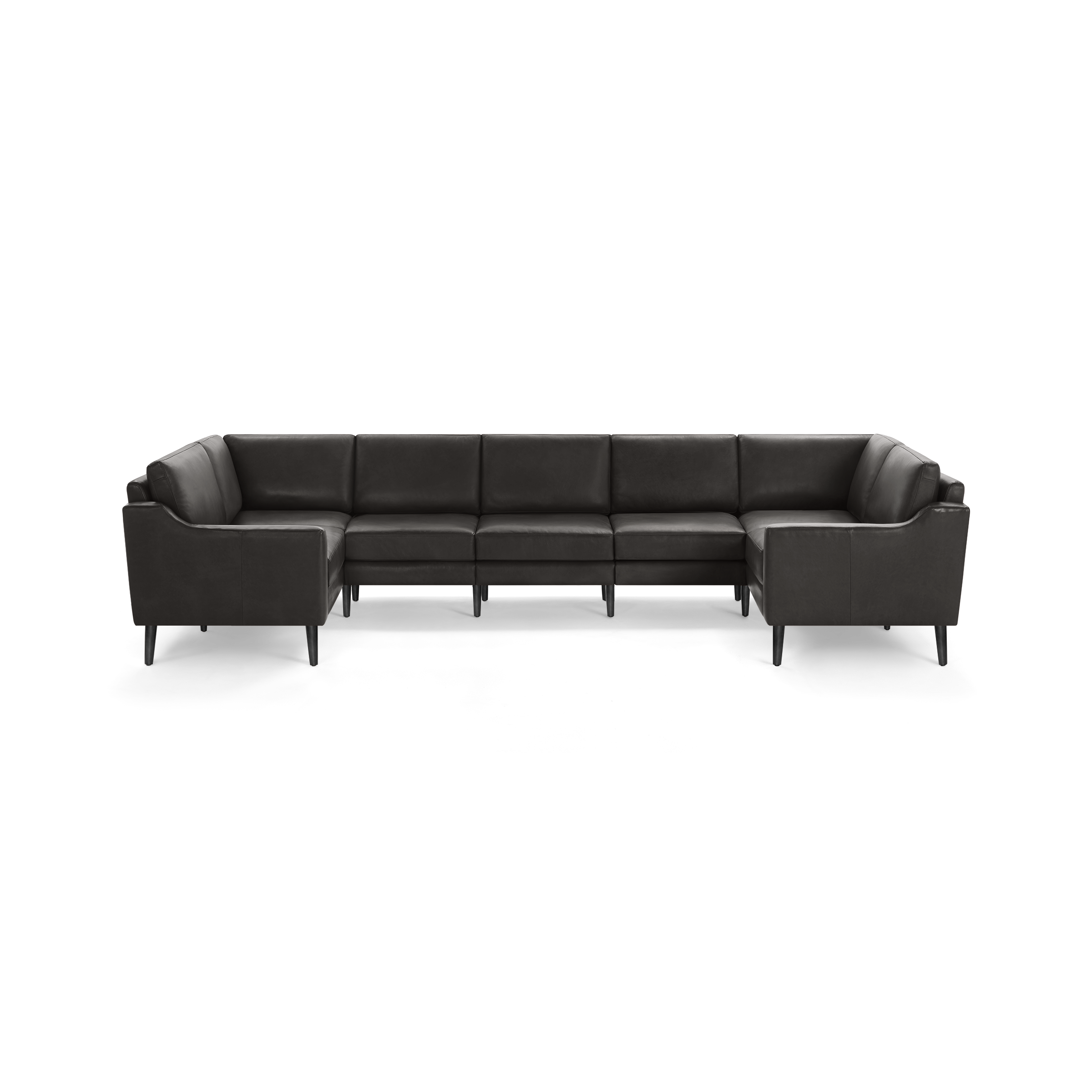 Large dark brown leather sectional sofa with cushioned seats, high armrests, and black angled legs on a black background.