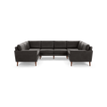 Large dark gray leather U-shaped sectional sofa with clean lines and wooden tapered legs on a black background.