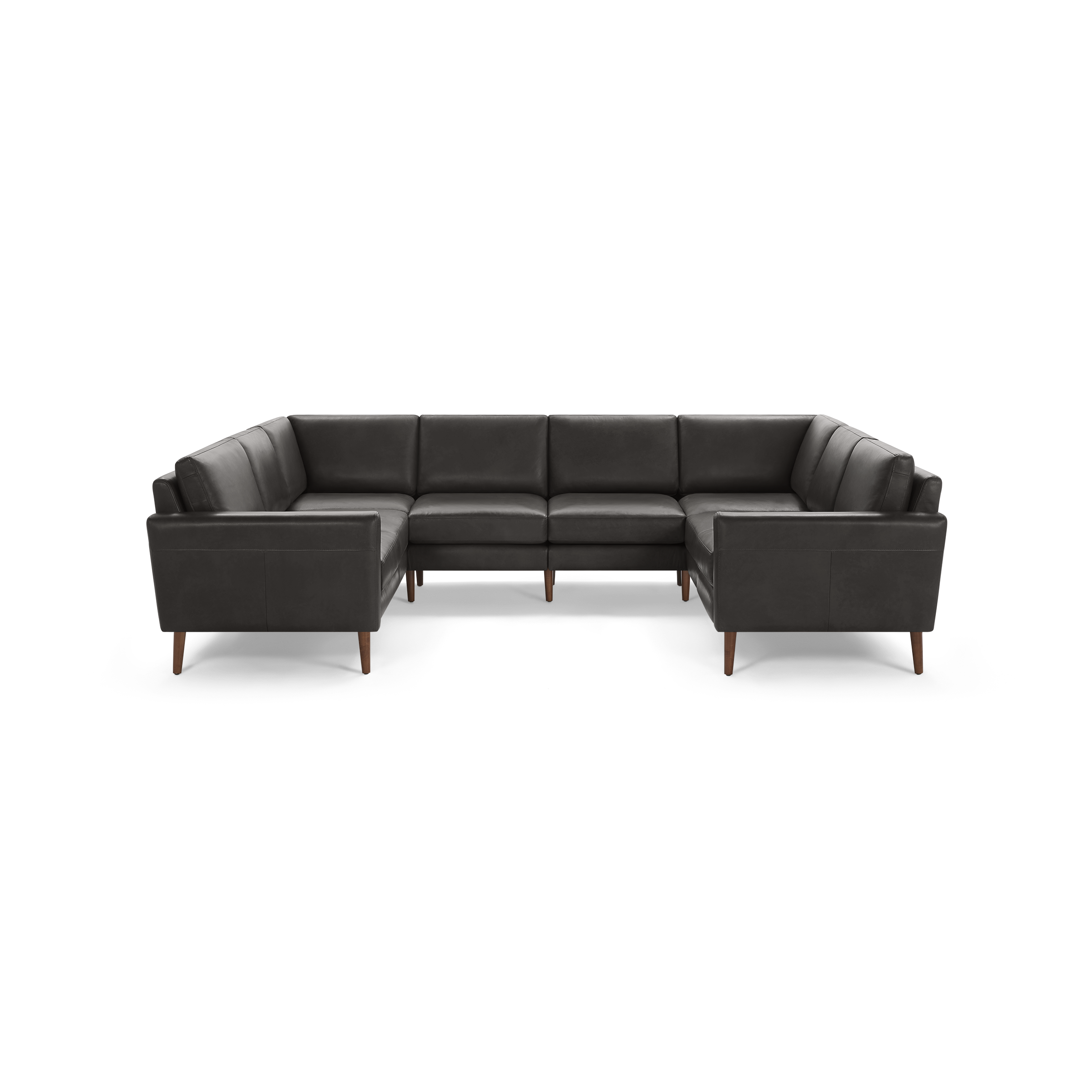 Large dark gray leather U-shaped sectional sofa with clean lines and wooden tapered legs on a black background.