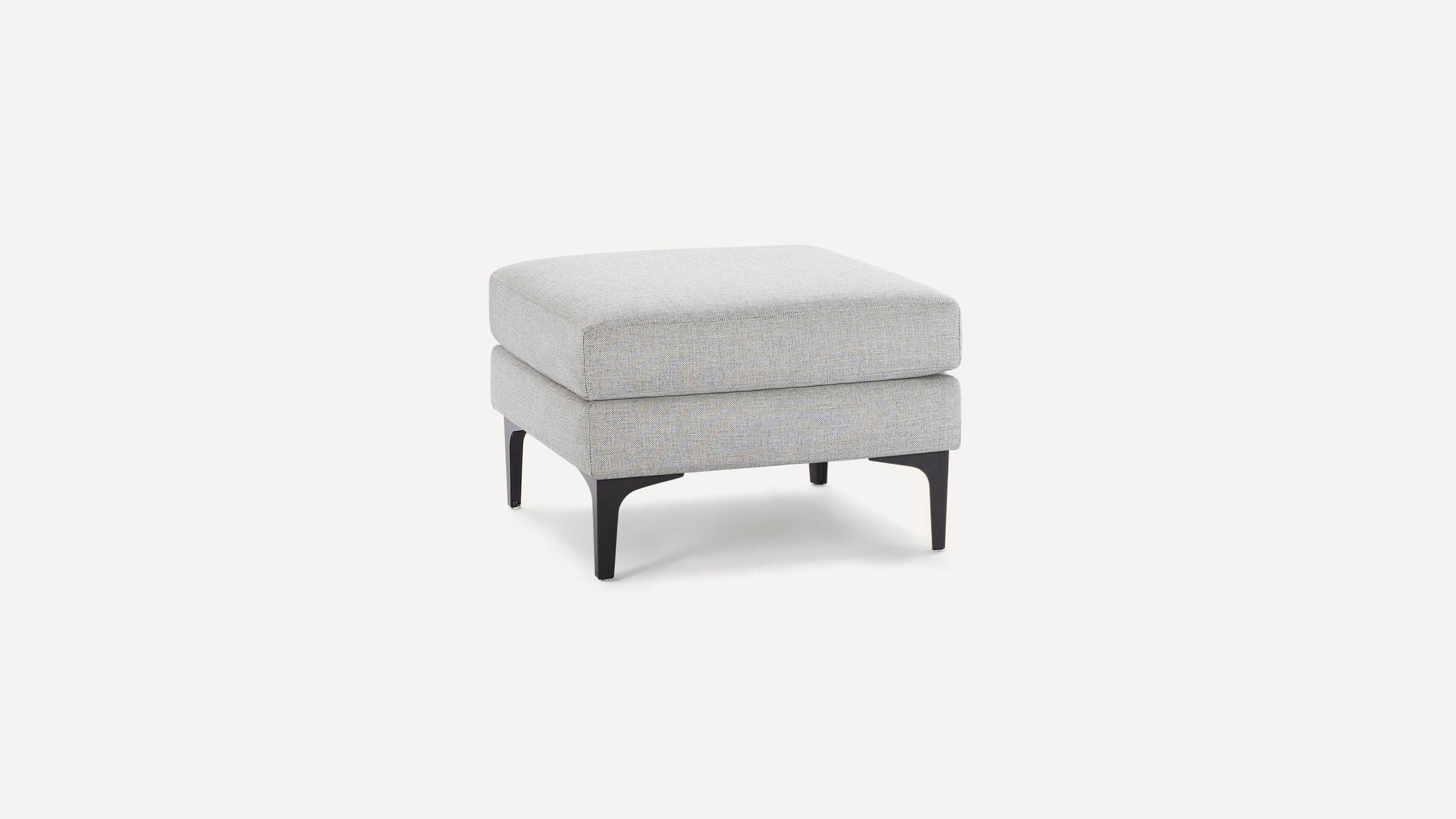 Light gray square ottoman with cushioned top and slender black metal legs on a white background.