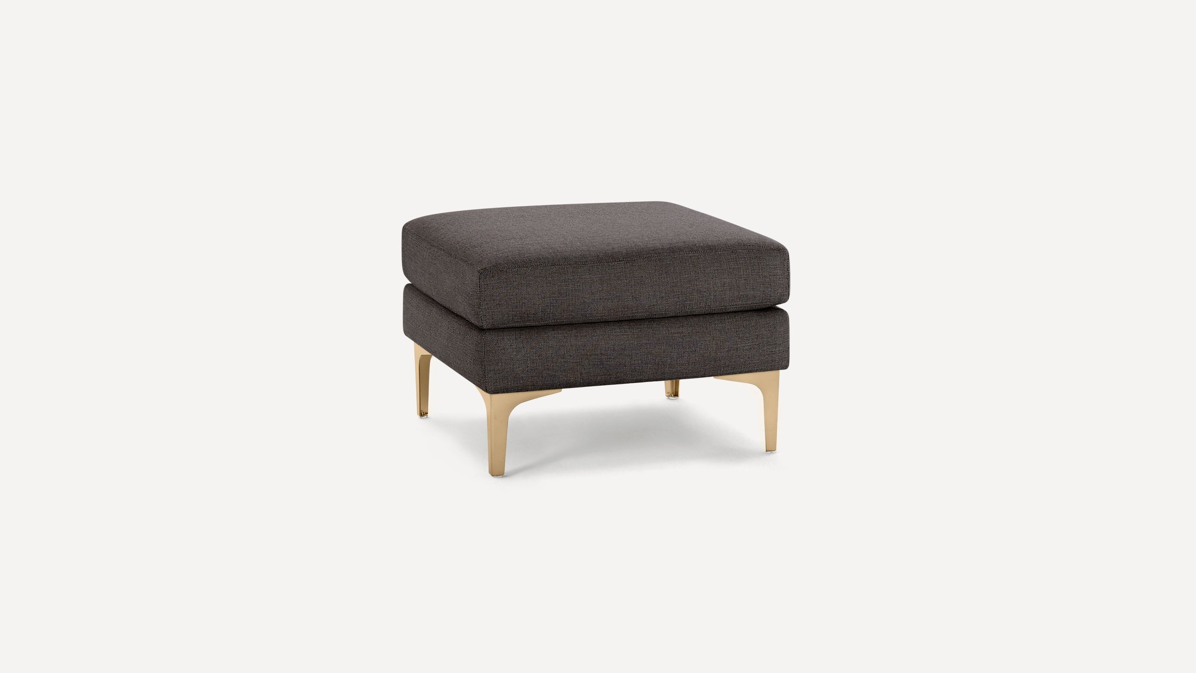 Square dark gray upholstered ottoman with gold metal legs, featuring a double layered cushion design.