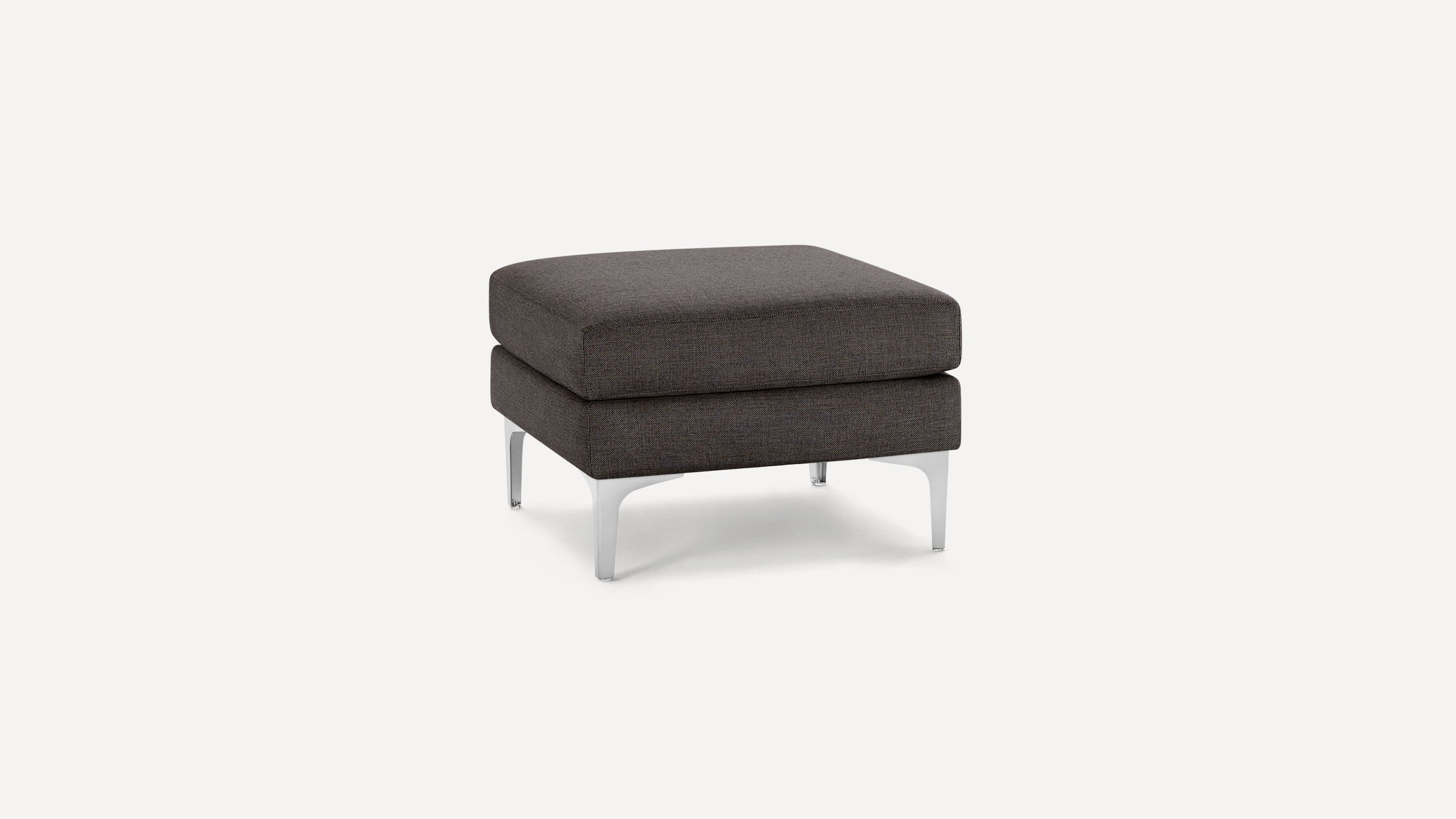 Square charcoal gray upholstered ottoman with two cushioned layers and sleek silver metal legs on a white background.