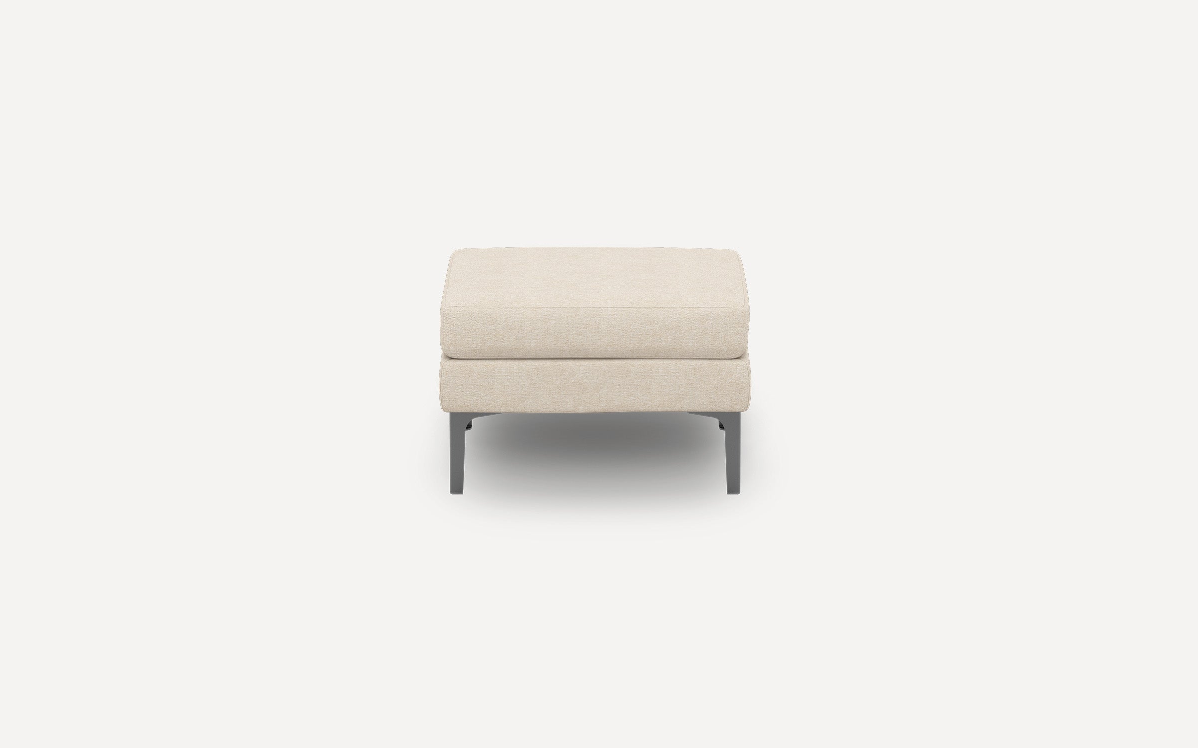 Beige upholstered ottoman with clean lines and black metal legs, shown against a plain white background.