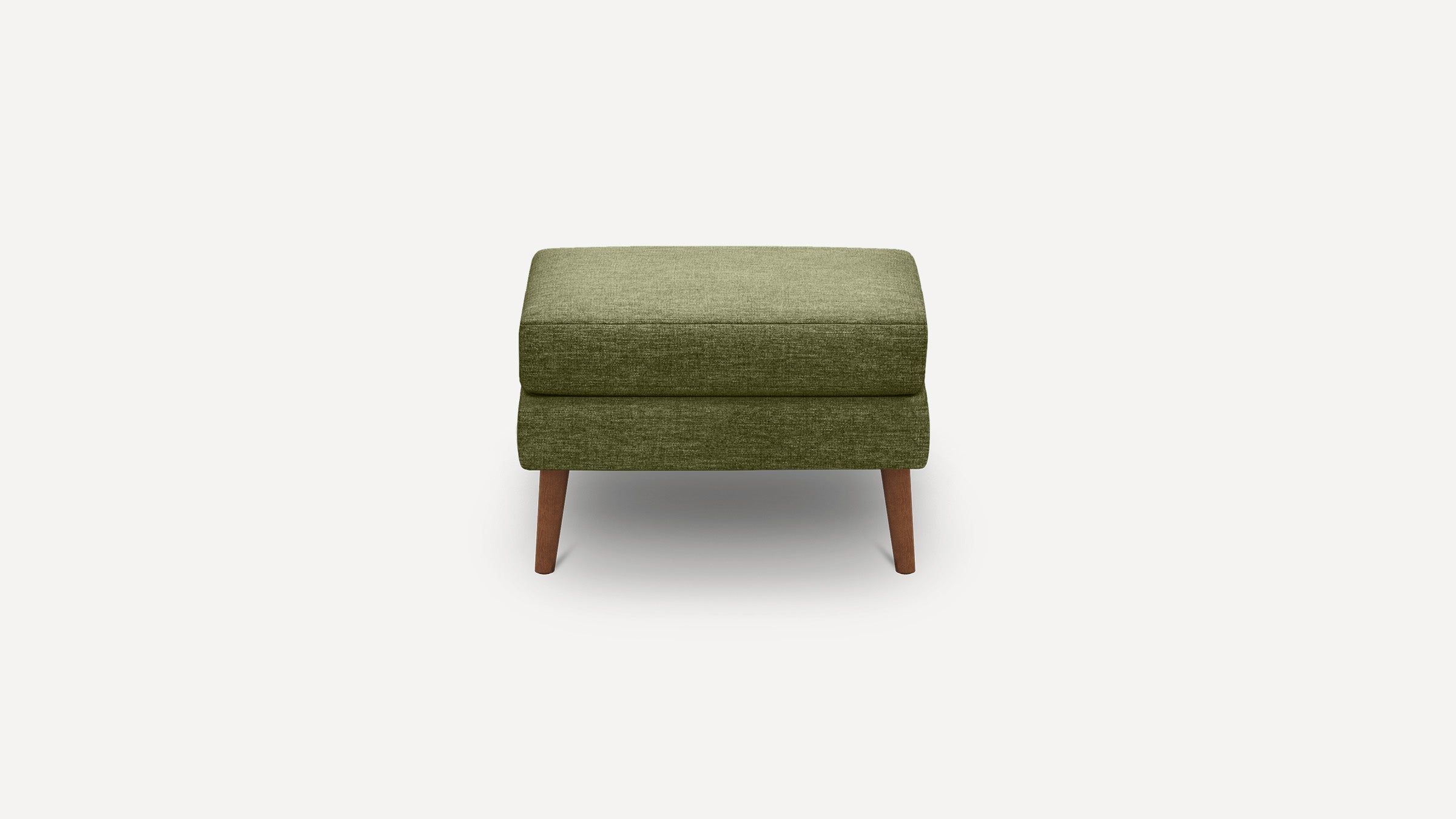 Green fabric ottoman with wooden tapered legs, rectangular cushioned top and minimalist modern design.