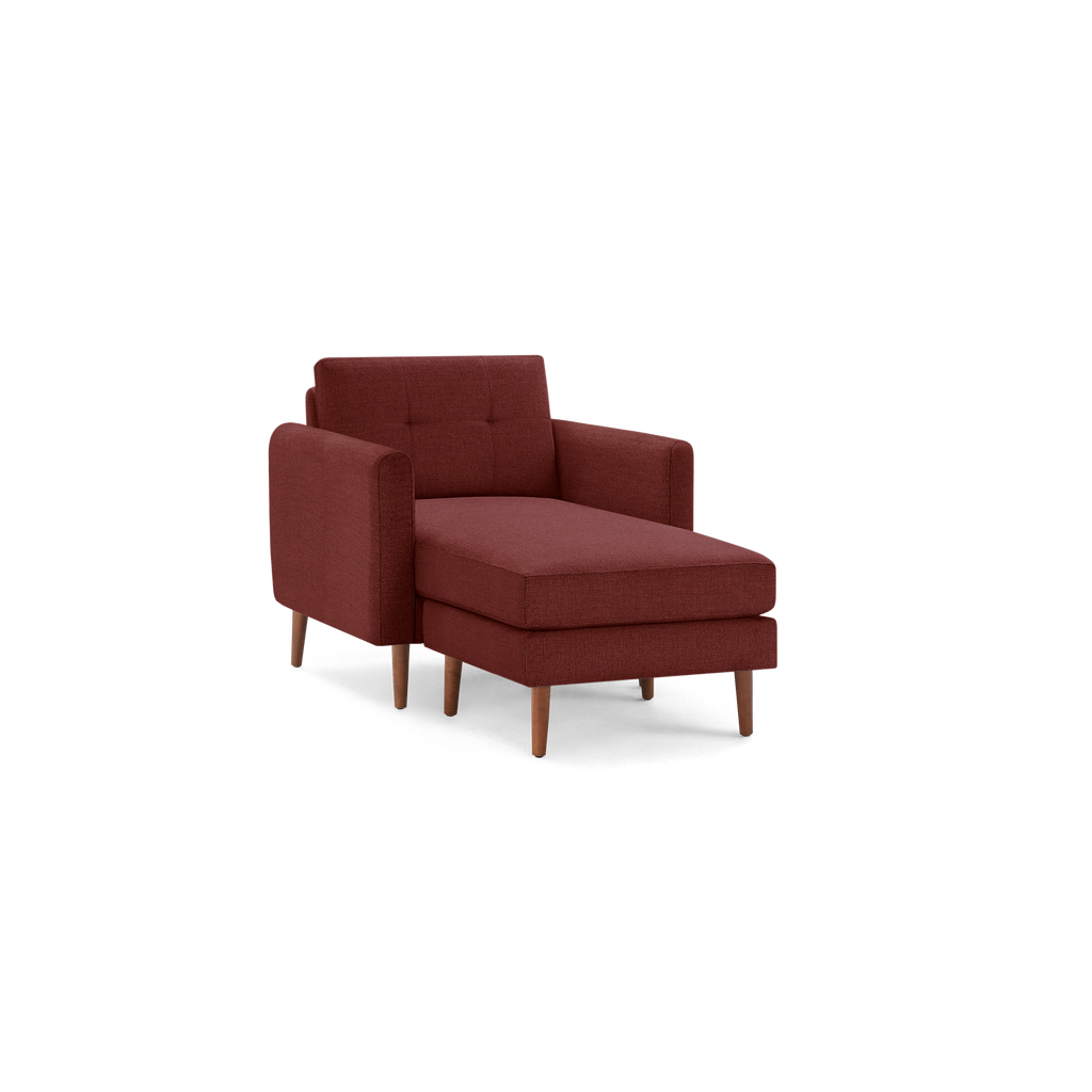 Mid-century modern red fabric chaise lounge chair with tufted backrest and wooden tapered legs.