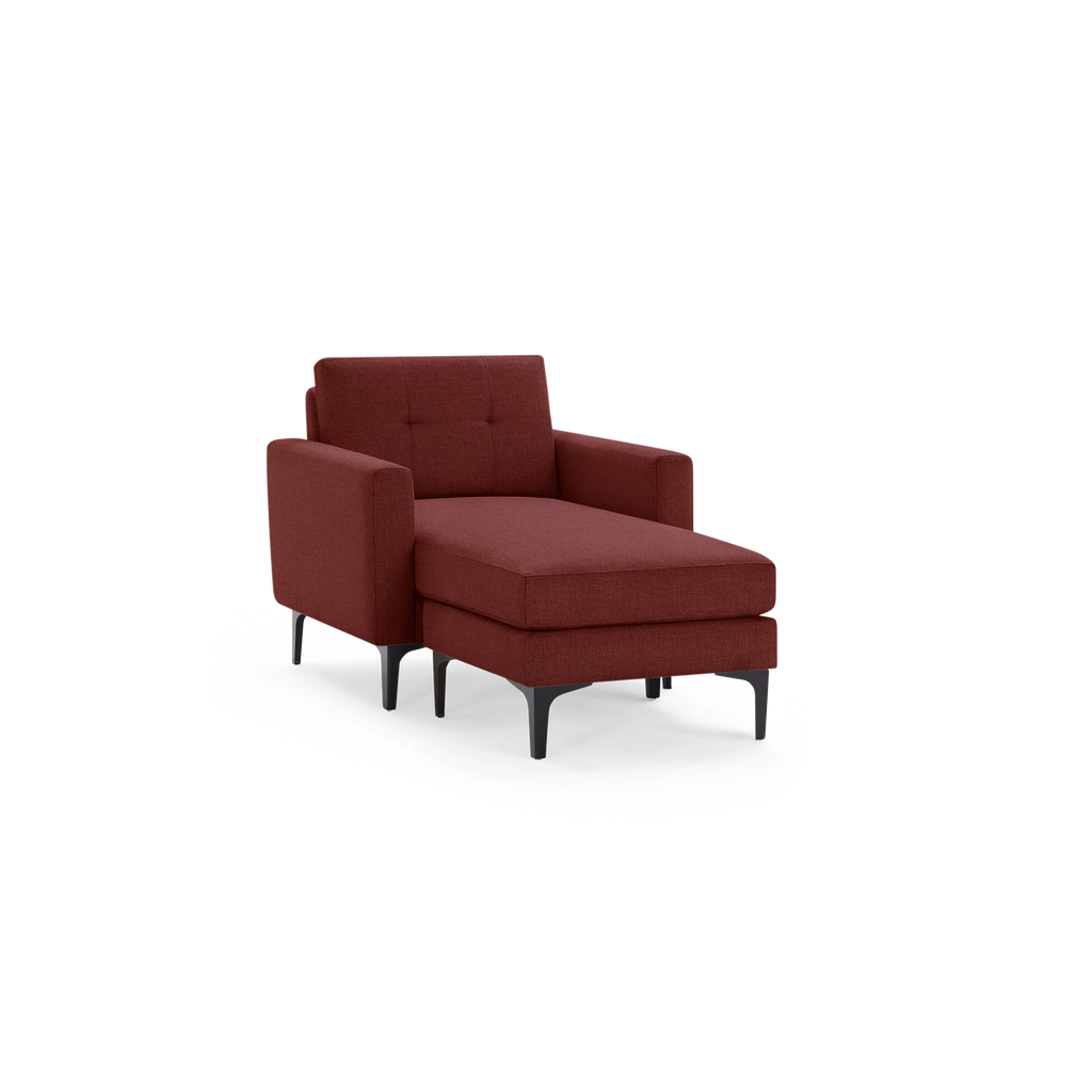 Modern chaise lounge chair with dark red fabric upholstery, button-tufted backrest, armrests, and black tapered legs.