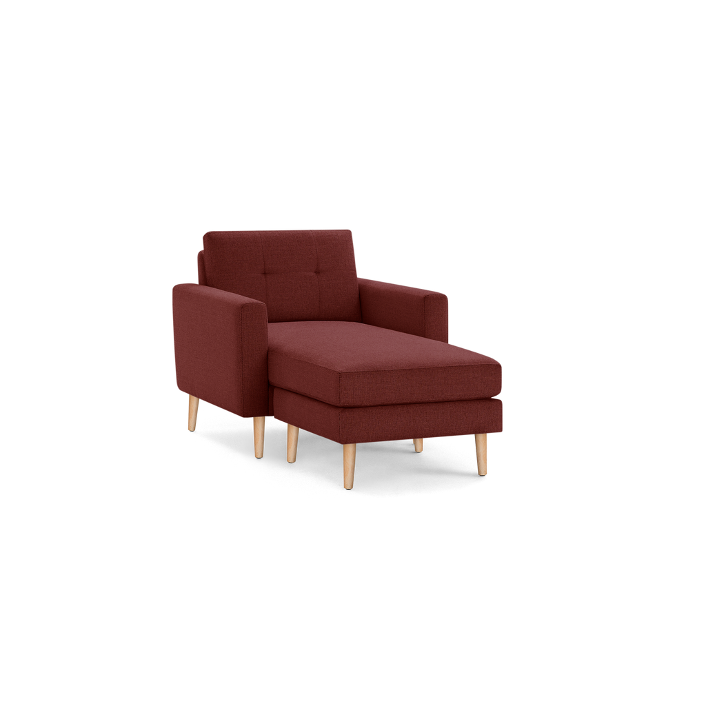 Modern single-seat chaise lounge chair with deep red upholstery and light wooden legs, featuring armrests and a tufted backrest.