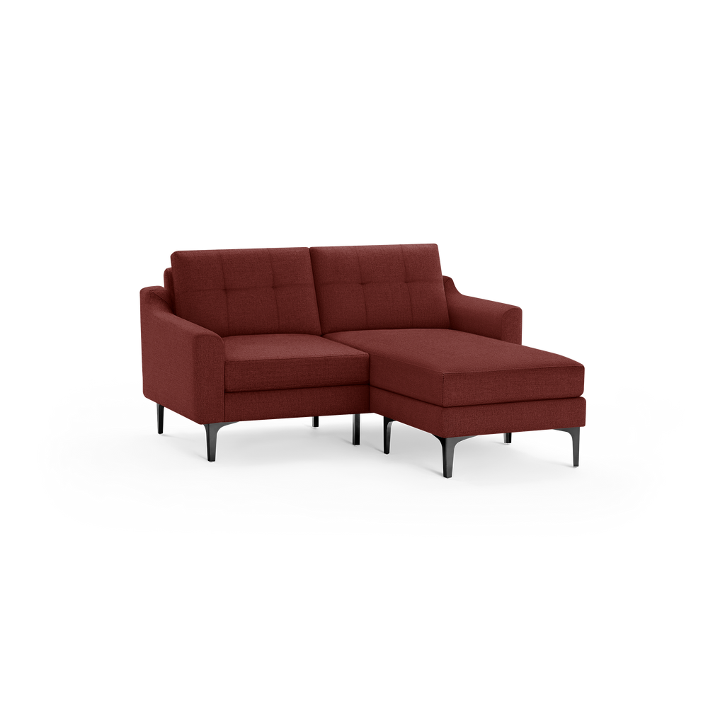 Modern sectional sofa in deep red fabric with tufted back cushions, slim armrests, and black angled legs.