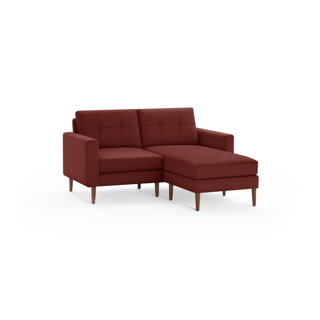 Modern L-shaped sectional sofa in deep red fabric with tufted back cushions and wooden tapered legs.