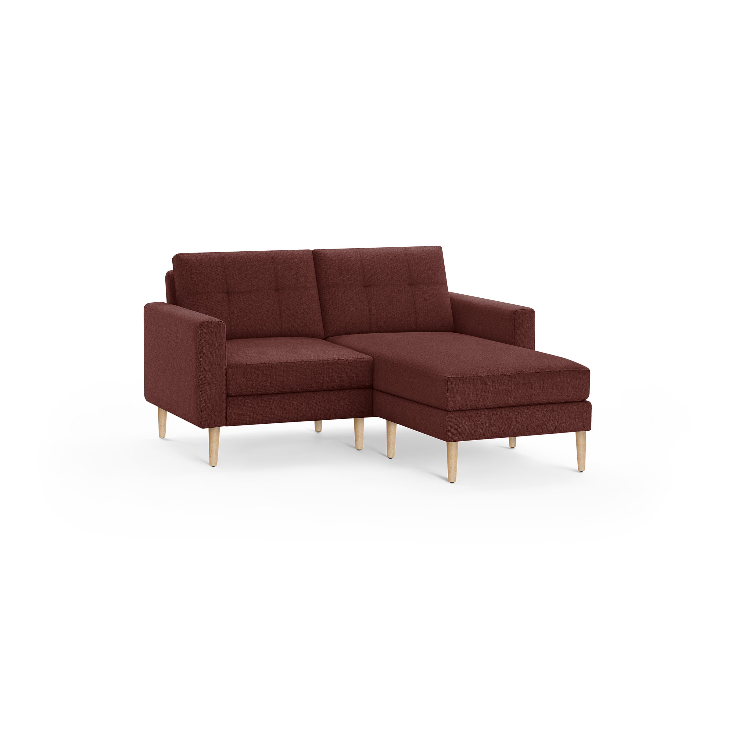 Modern sectional sofa with right chaise, upholstered in dark red fabric, featuring tufted back cushions and light wooden legs.