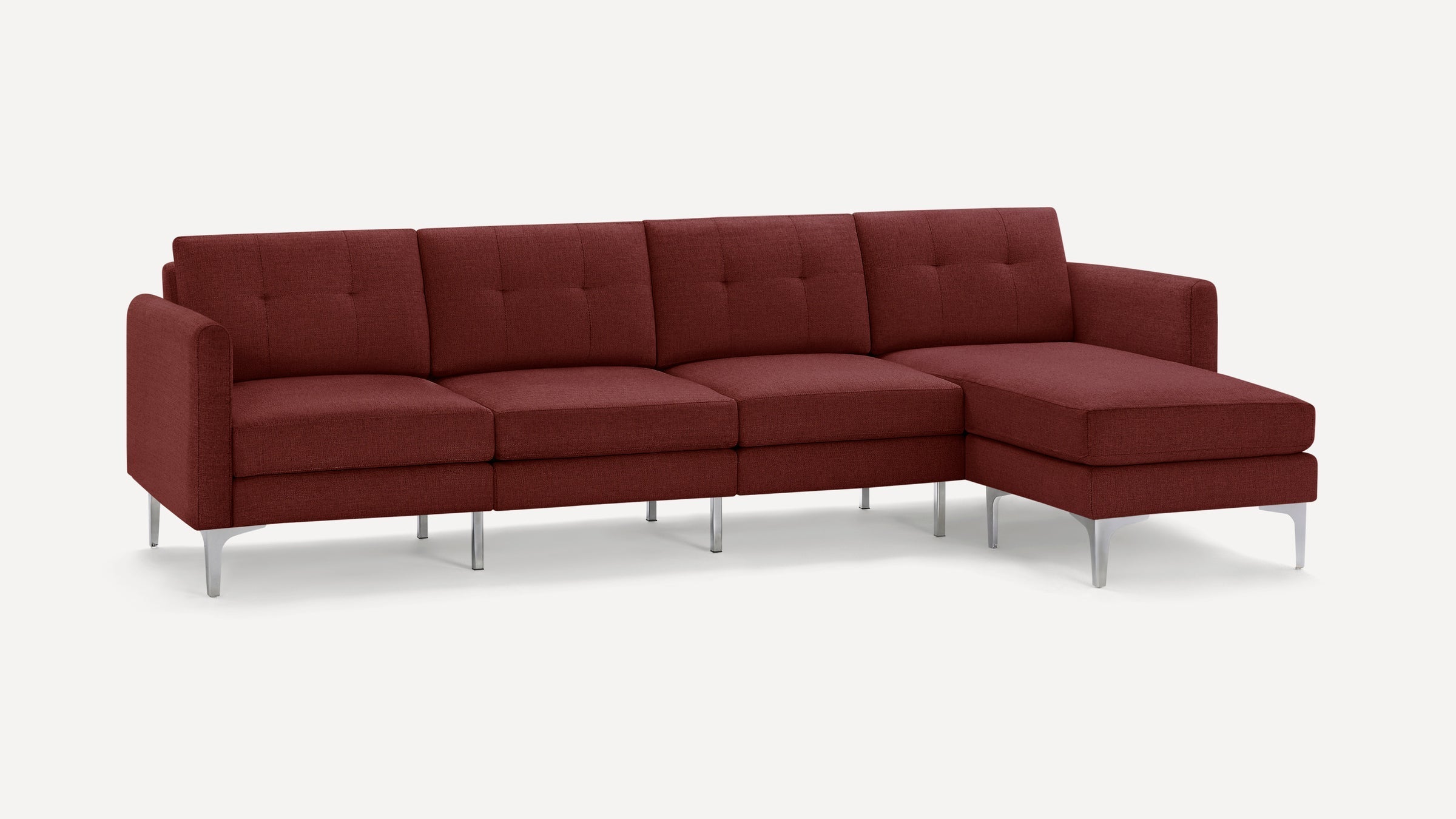 Modern sectional sofa in rich burgundy fabric with tufted back cushions and sleek silver metal legs on white background.