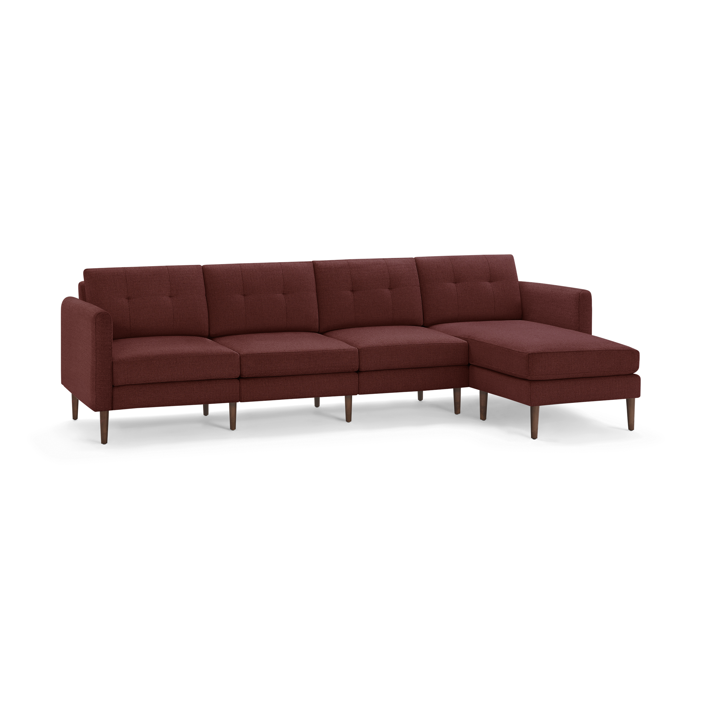 Mid-century modern sectional sofa with tufted cushions, wrapped in rust-red fabric and supported by tapered wooden legs.