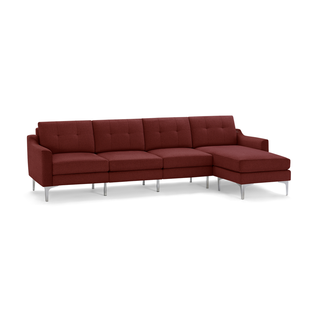 Modern L-shaped sectional sofa in deep red fabric with tufted back cushions and sleek metal legs.