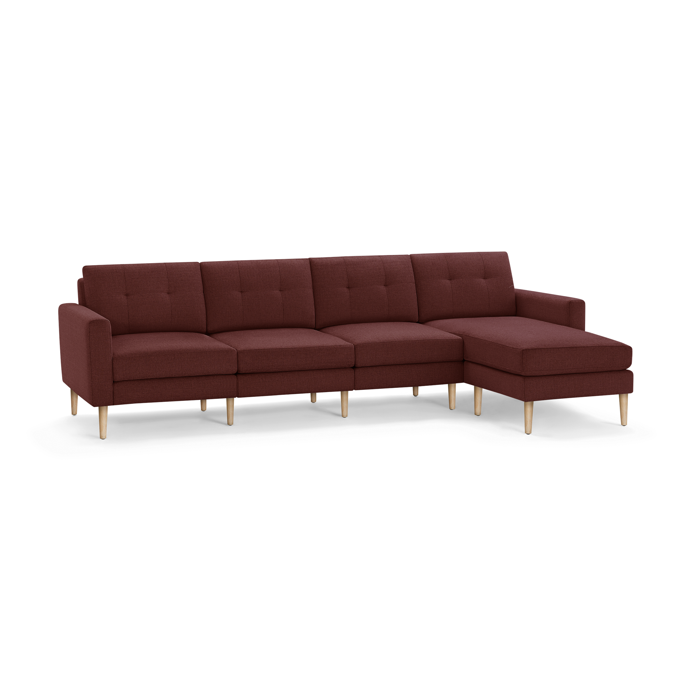 Modern L-shaped sectional sofa with deep red fabric upholstery, button-tufted back cushions, wooden legs, and a chaise on the right side.