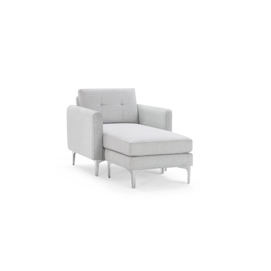 Light gray upholstered single arm chaise lounge with tufted backrest and slim, tapered legs.