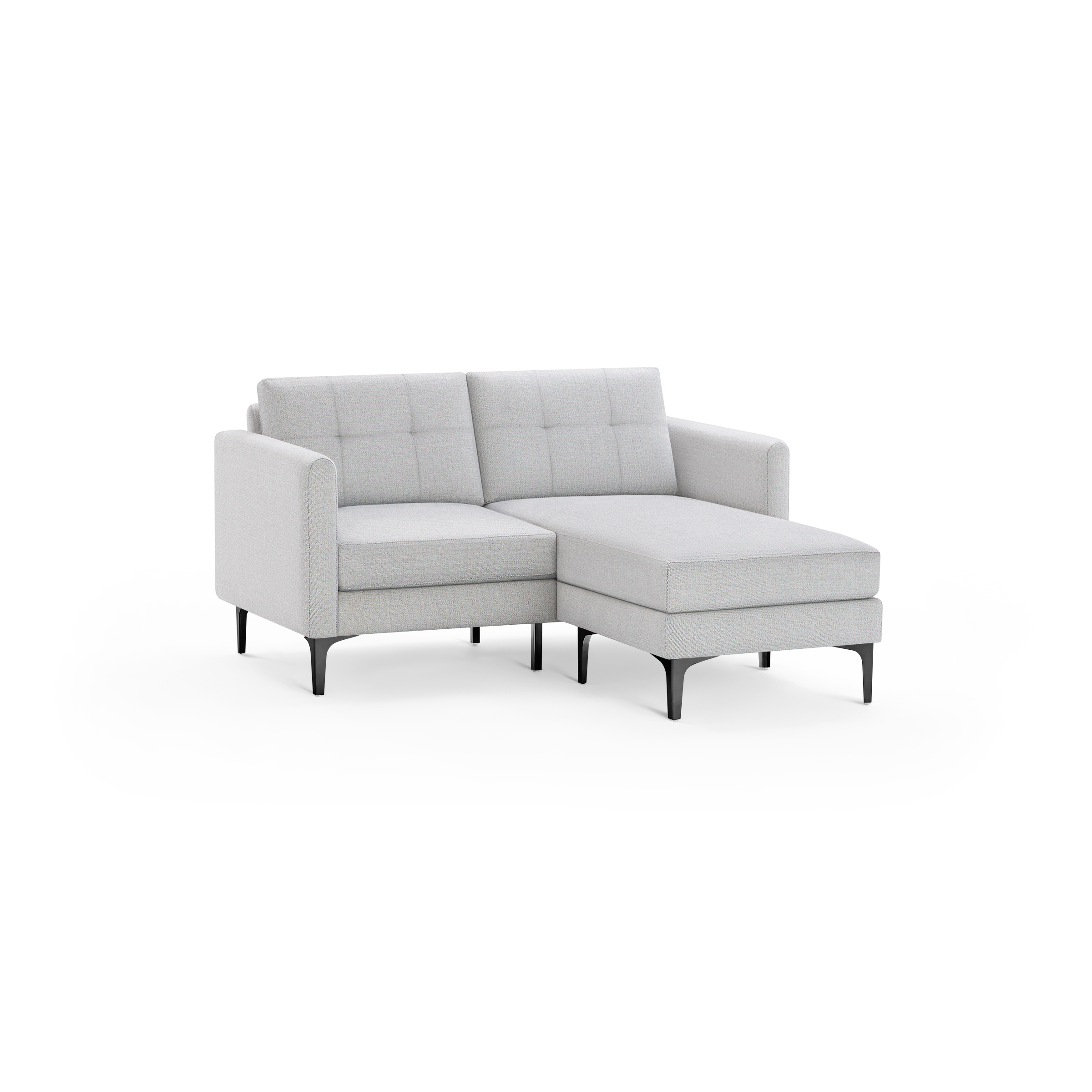 Light gray modern chaise lounge sofa with tufted back cushions, slim arms, and black angled legs, isolated on black background.