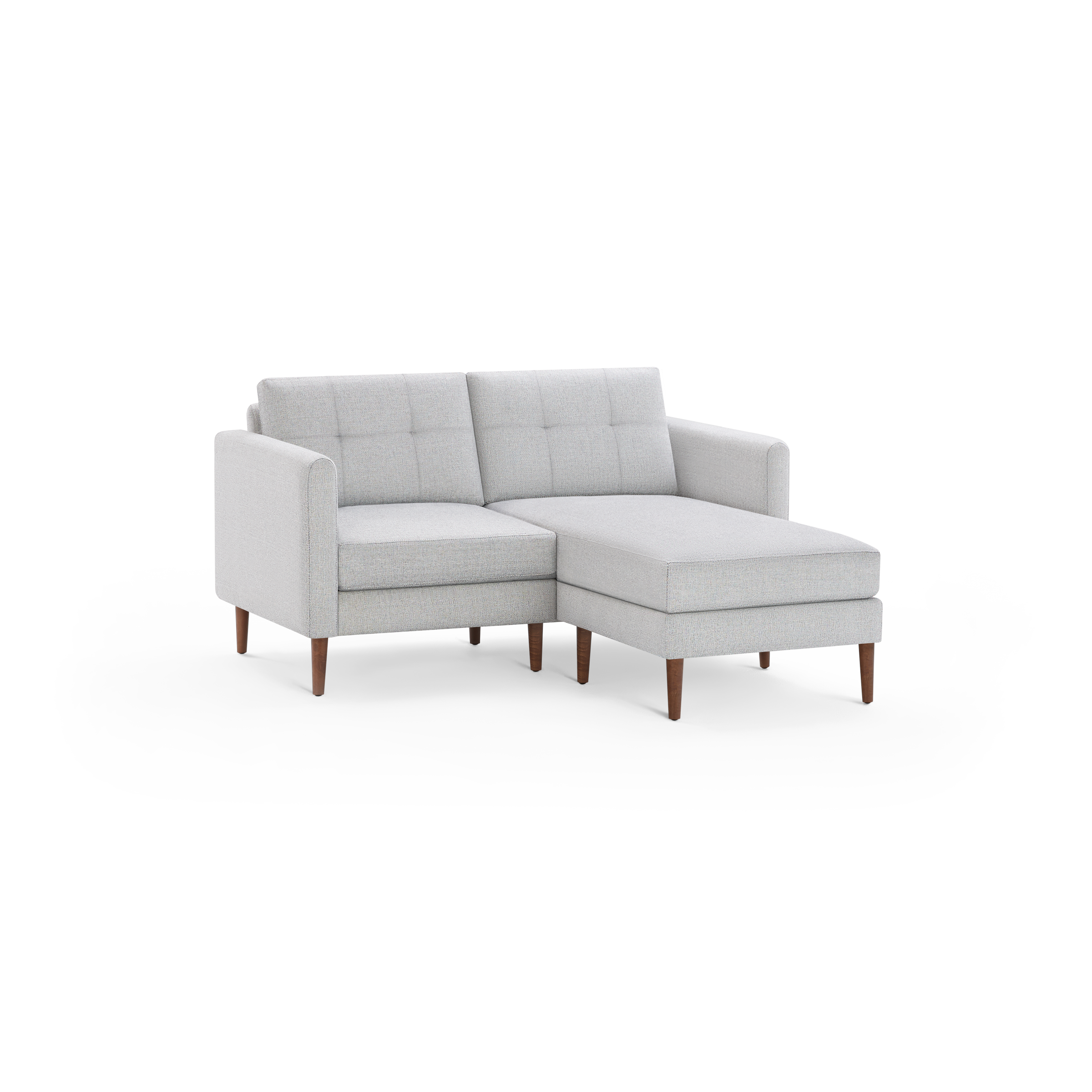Light gray upholstered sectional sofa with tufted back cushions and wooden legs, featuring a chaise lounge on the right side.