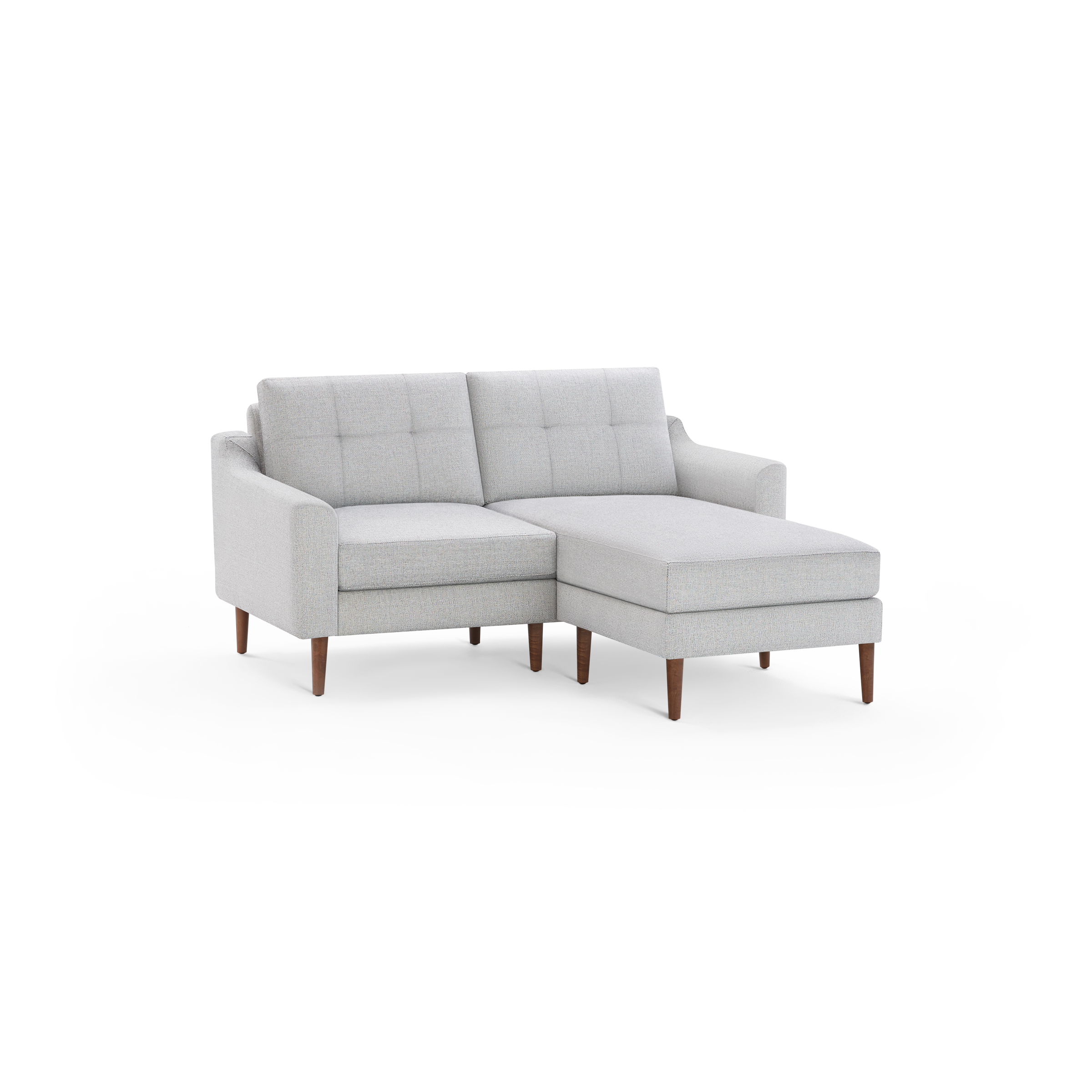 Light gray modern sectional sofa with button-tufted back cushions, wooden legs, and a chaise lounge on the right side.
