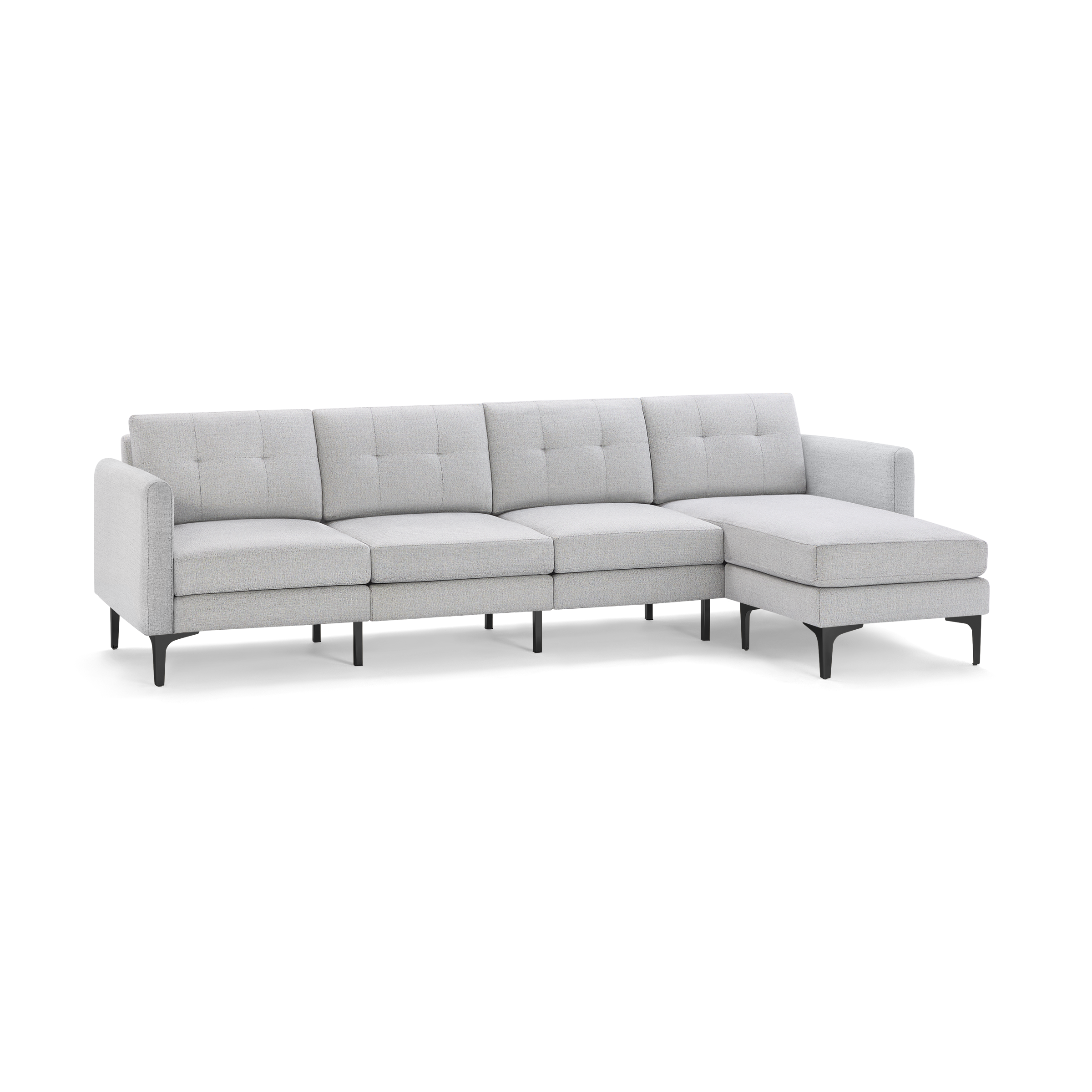 Light gray fabric sectional sofa with tufted cushions, L-shaped design, and black slender legs.