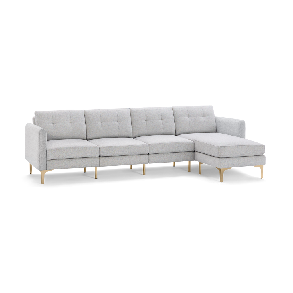 Light gray modern sectional sofa with tufted back cushions and gold metal legs, featuring a right-side chaise lounge.