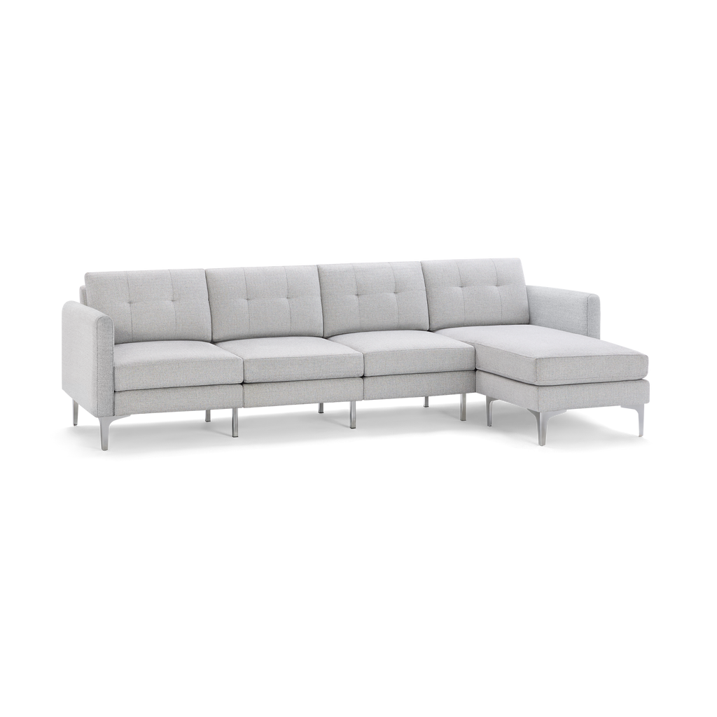 Light gray fabric sectional sofa with tufted back cushions, metal legs, and a right-side chaise lounge.