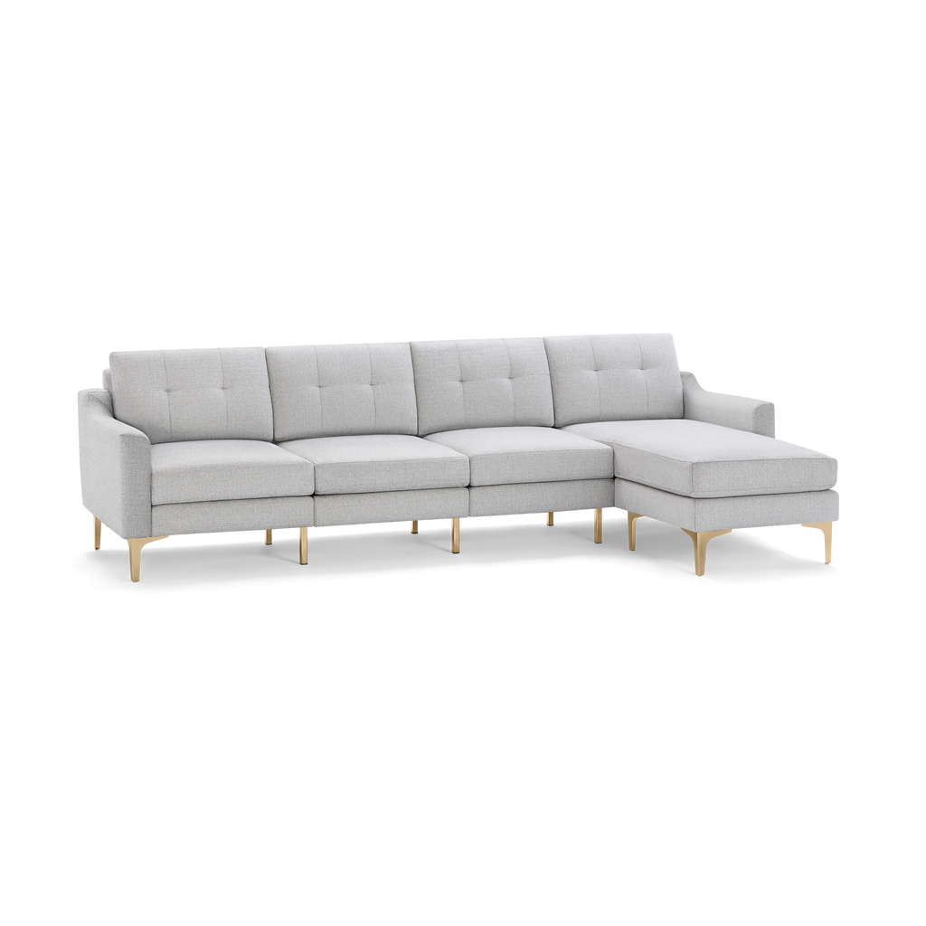 Light gray modern sectional sofa with tufted back cushions, slim armrests, and gold-toned metal legs, featuring a right-side chaise lounge.