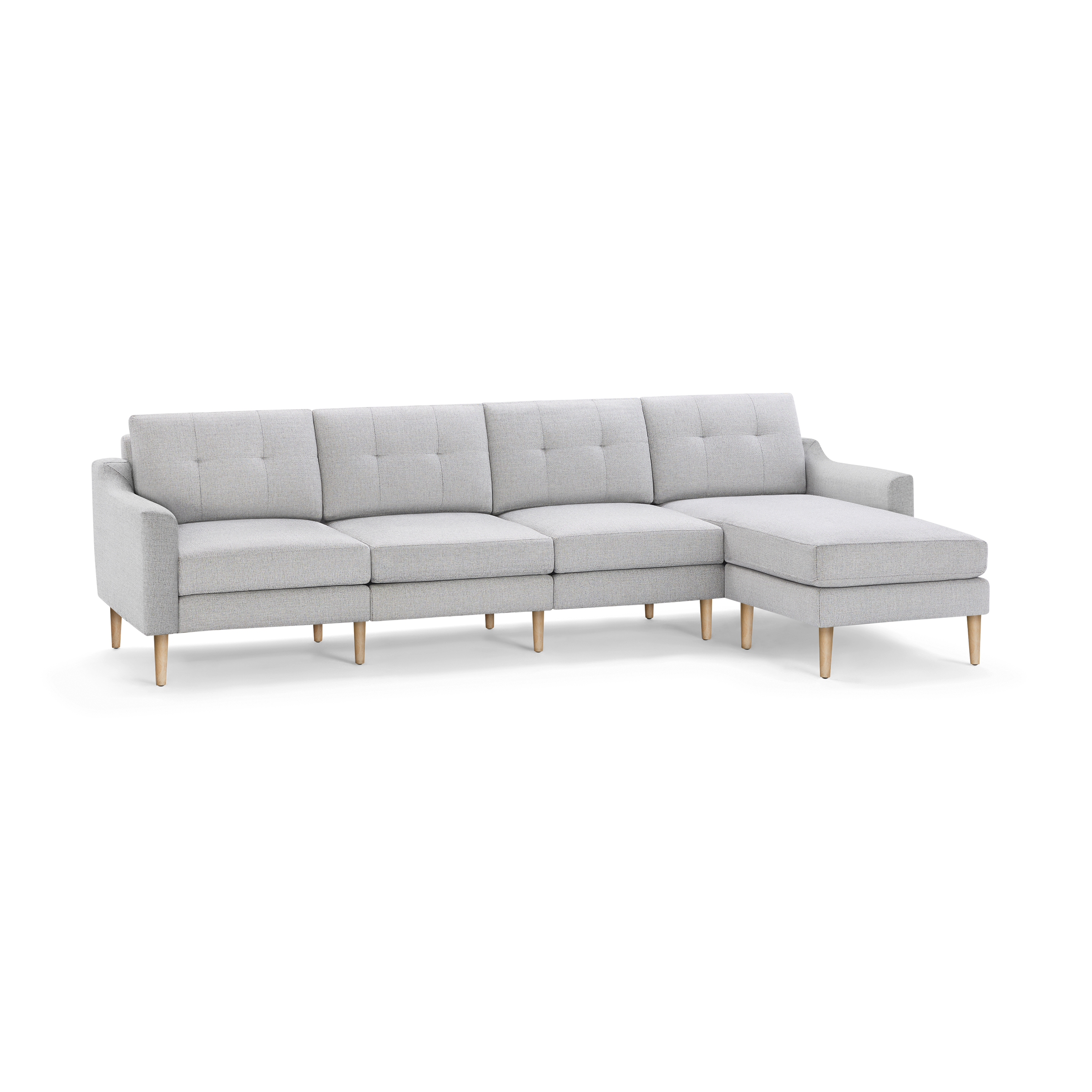 Light gray fabric sectional sofa with tufted back cushions, wooden tapered legs, and an attached right-side chaise lounge.