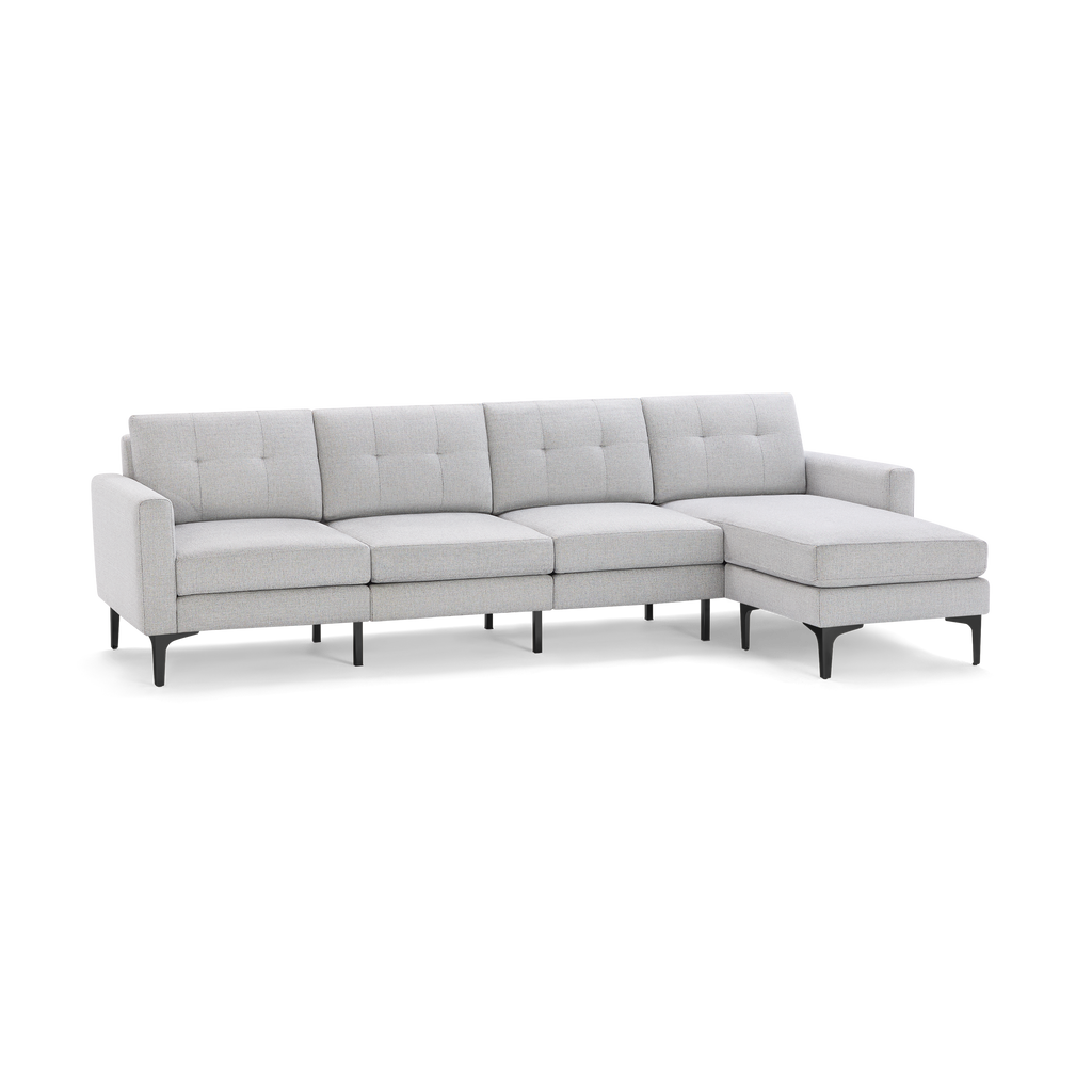 Light gray modern sectional sofa with tufted back cushions, slim armrests, and black metal legs, featuring a chaise lounge on the right side.