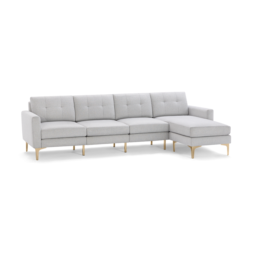 Light gray sectional sofa with tufted back cushions, slim armrests, and gold metal legs, featuring a right-side chaise lounge.