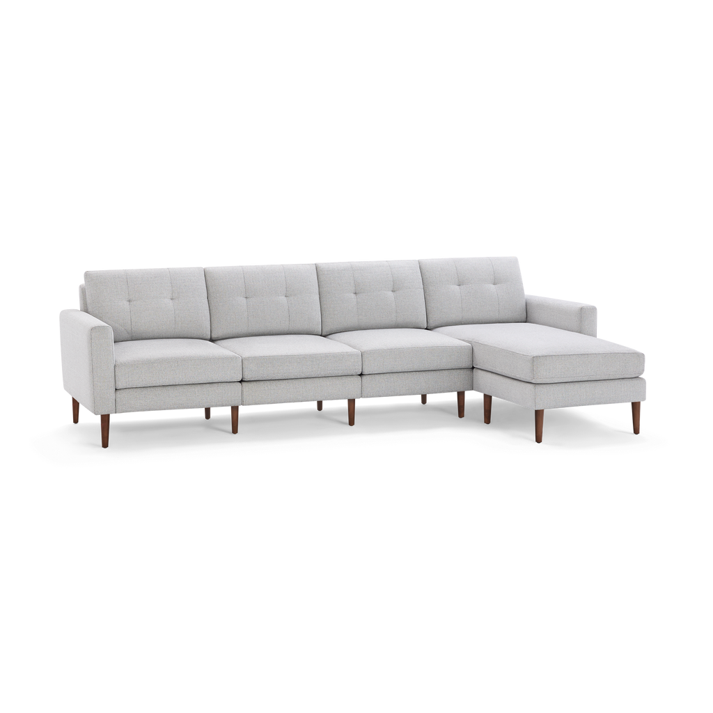 Light gray modern sectional sofa with tufted cushions and wooden legs, featuring a right-side chaise lounge.