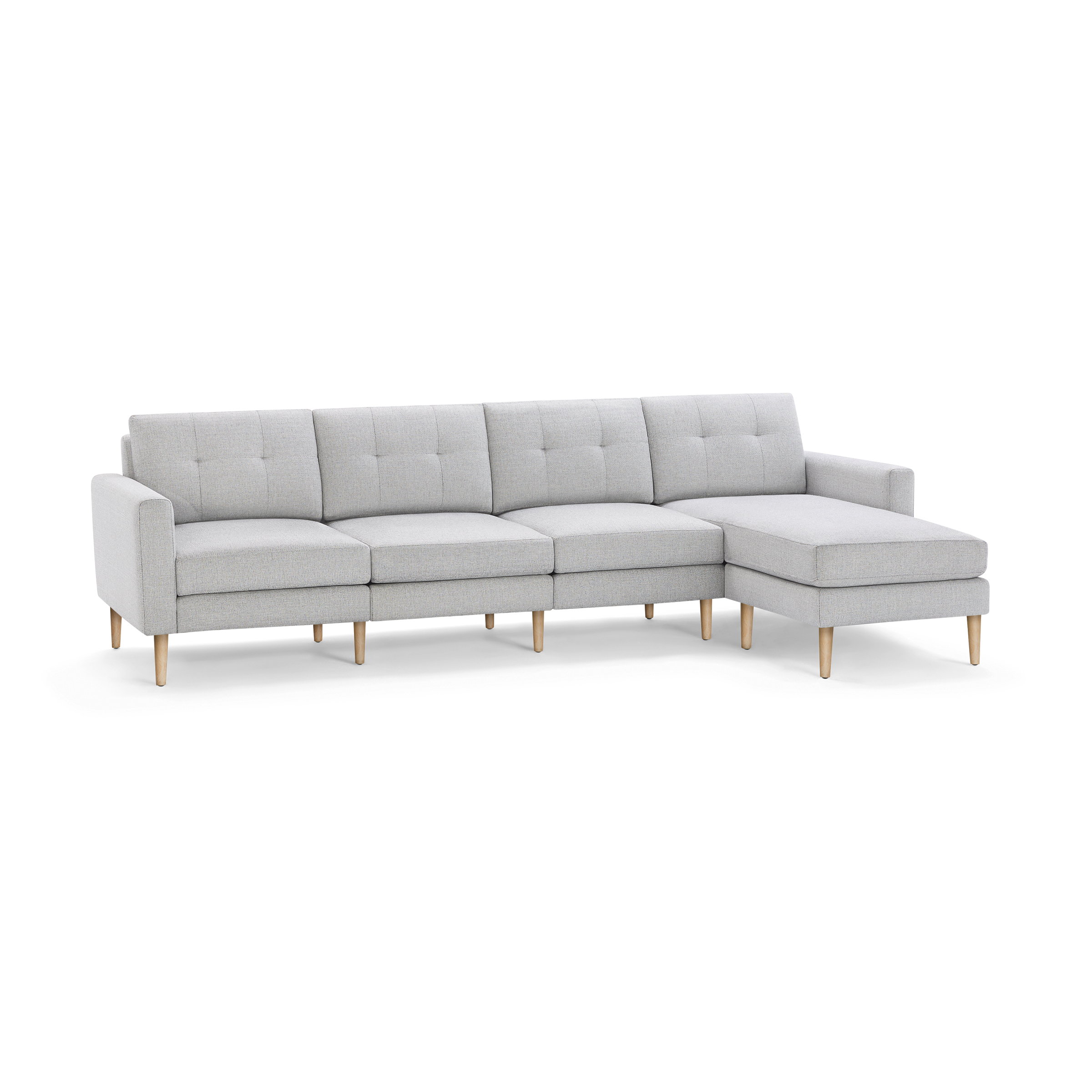 Light gray fabric sectional sofa with tufted back cushions, wooden legs, and right-side chaise lounge, modern design.