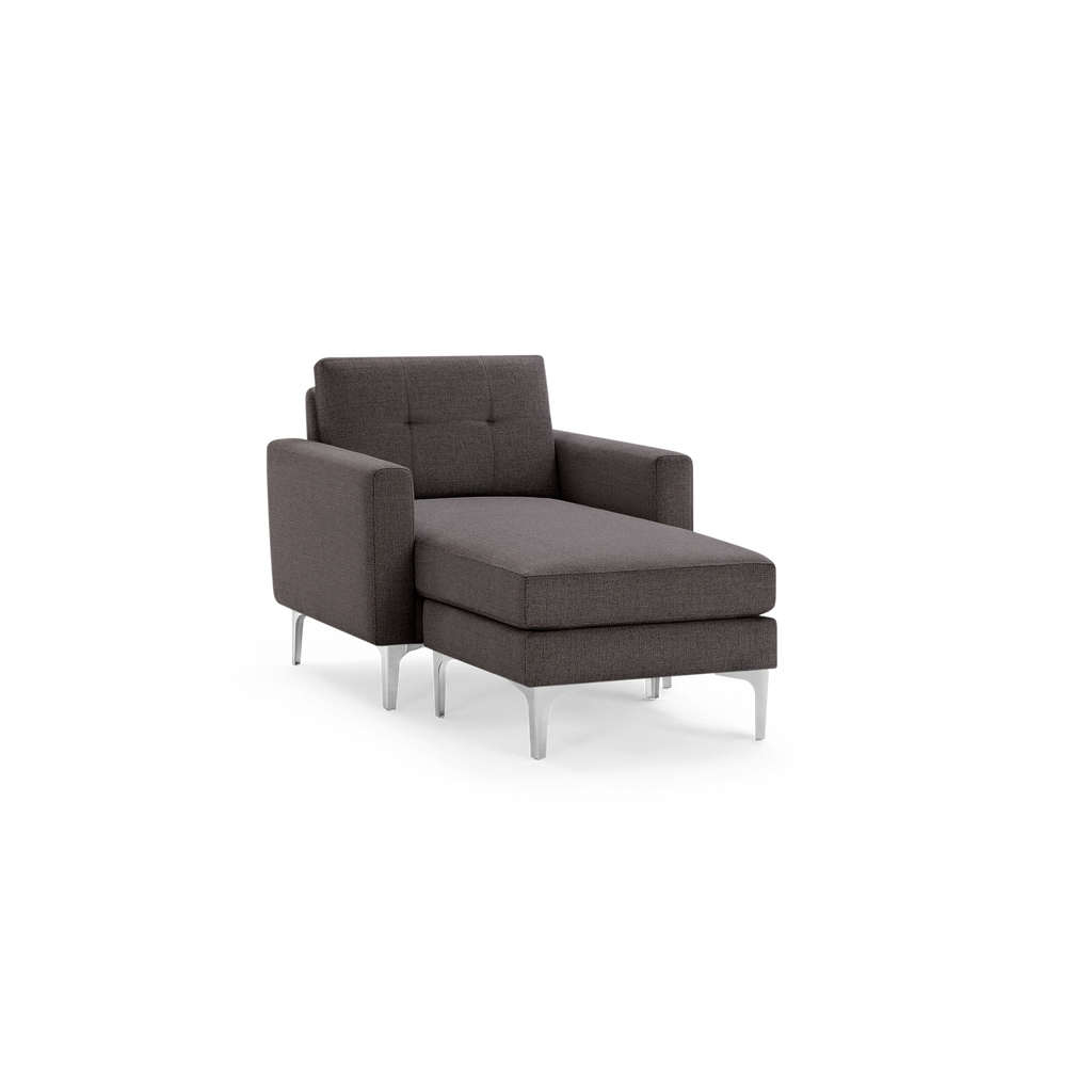 Dark gray upholstered chaise lounge with metal legs and tufted back cushion, featuring armrests on both sides.